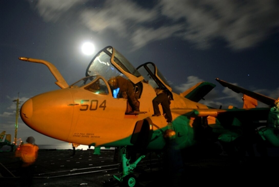 Sailors conduct a post-flight check on the cockpit of an EA-6B Prowler aboard the aircraft carrier USS Kitty Hawk, June 17, 2008. The Kitty Hawk is returning to the United States for decommissioning after 47 years of service. The ship will be replaced by nuclear-powered aircraft carrier USS George Washington. 