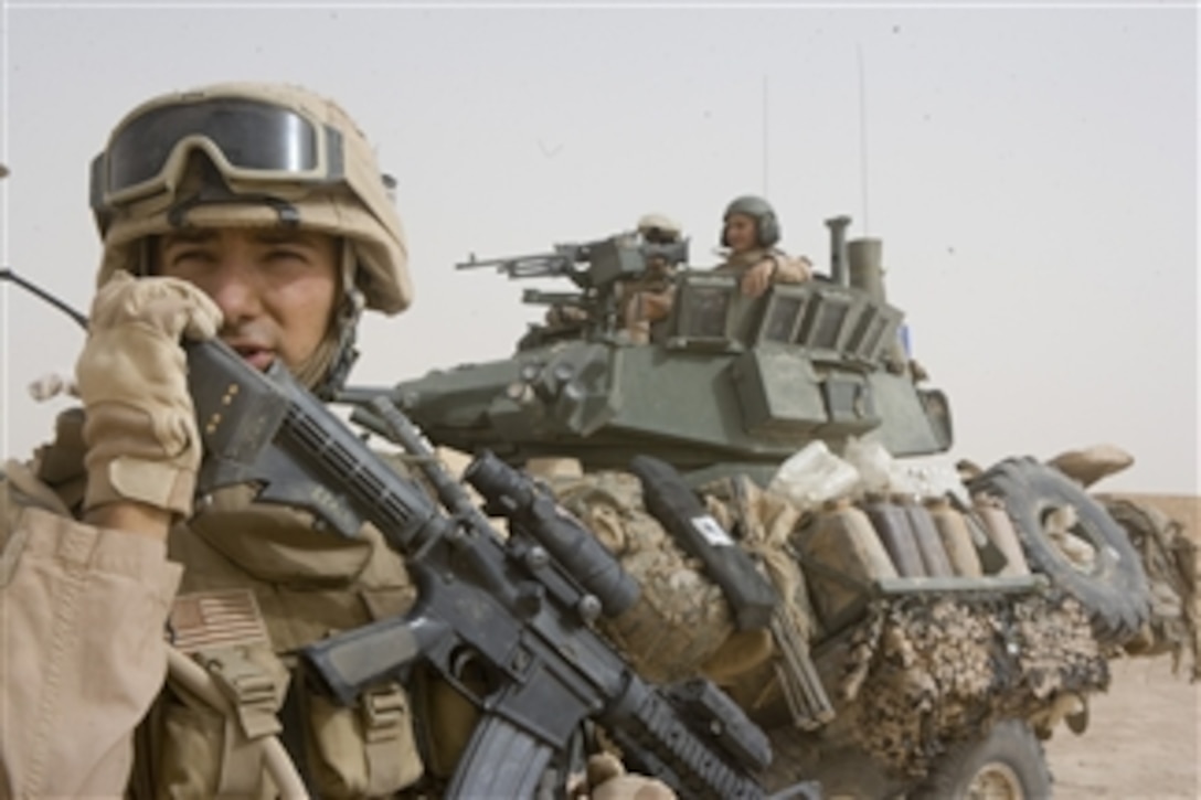 U.S. Marine Corps Sgt. Daniel Leach radios fellow Marines during an operation in the Al Anbar province of Iraq on June 11, 2008.  Leach is assigned to 2nd Platoon, Delta Company, 2nd Light Armored Reconnaissance Battalion, a ground combat element attached to Task Force Mechanized, Multi National Force - West.  