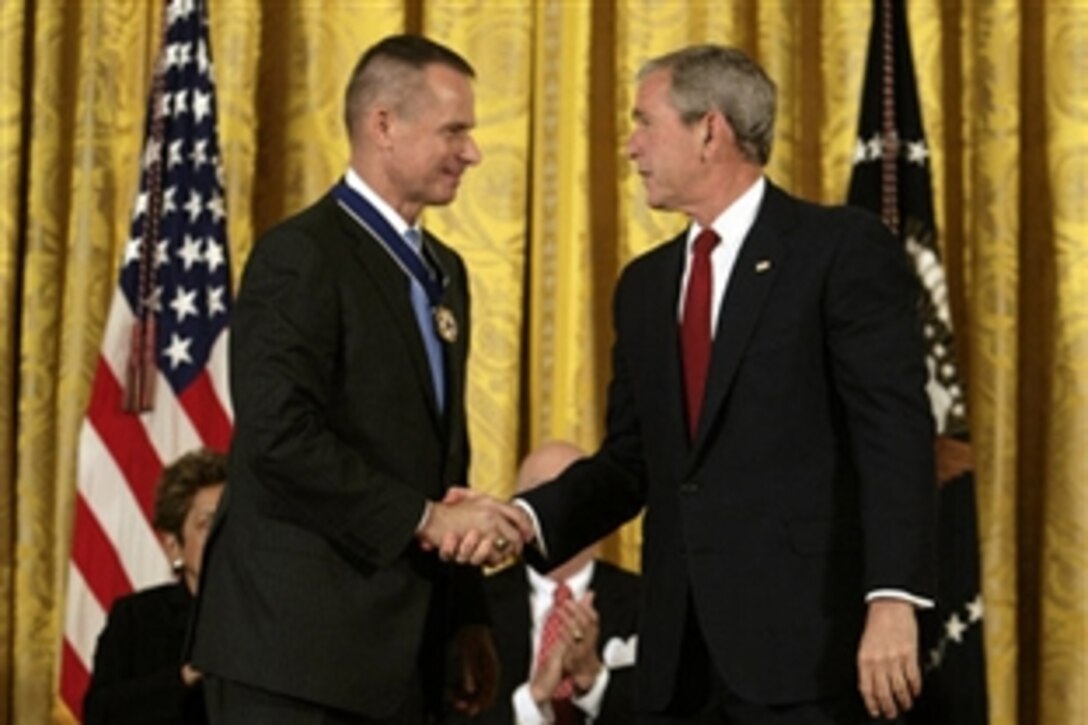 President Bush, right, shakes hands with retired Marine Gen. Peter Pace after presenting him with the Presidential Medal of Freedom, June 19, 2008, during the Presidential Medal of Freedom ceremony in the East Room at the White House. 