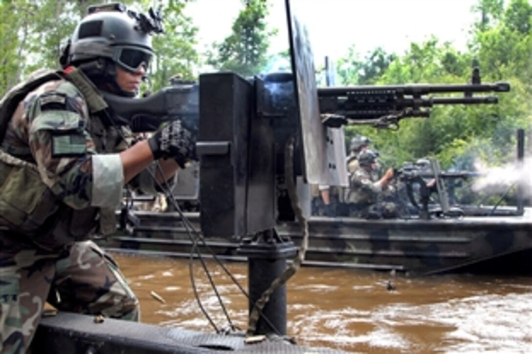 A special warfare combat craft crewmember assigned to Special Boat Team 22 fires an M-240N 7.62-mm machine gun during an exercise at a new riverine live-fire training range at Stennis Space Center, Miss., June 17, 2008. 