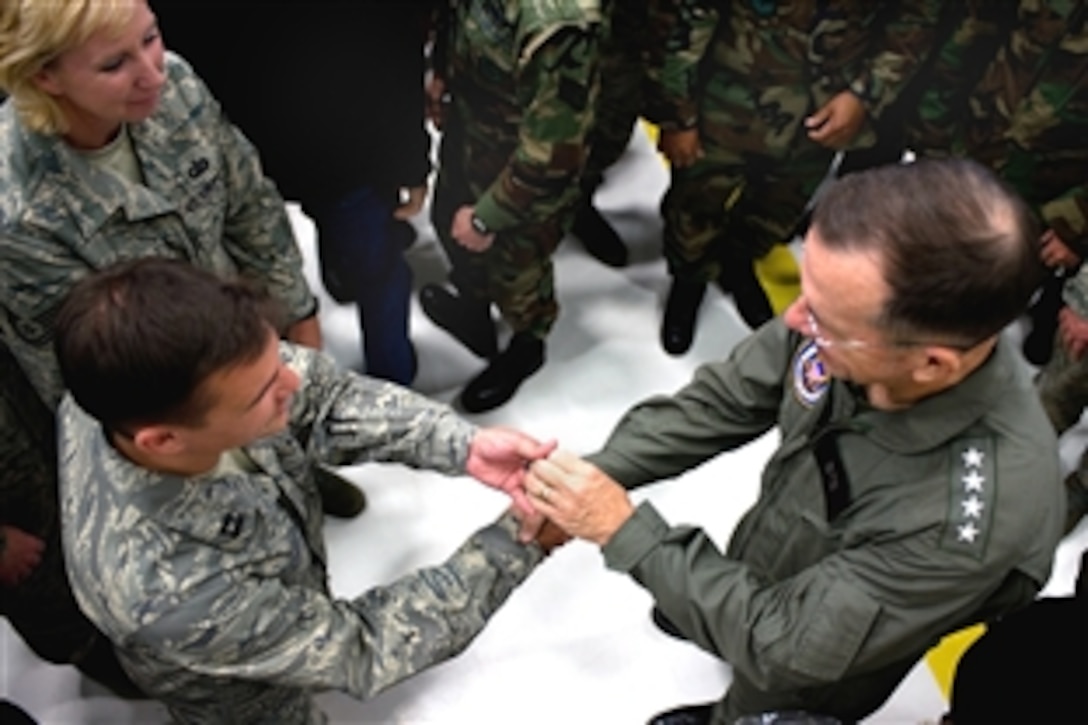 U.S. Navy Adm. Mike Mullen, chairman of the Joint Chiefs of Staff, hands out coins after he addressed airmen and civilians on McChord Air Force Base, Tacoma, Wash., June 18, 2008.  