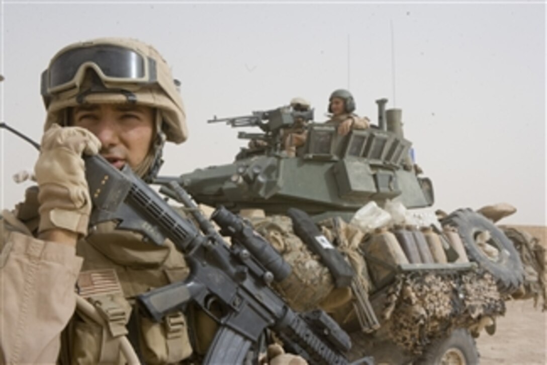 U.S. Marine Corps Sgt. Daniel Leach radios fellow Marines during an operation in the Al Anbar province of Iraq on June 11, 2008.  Leach is assigned to 2nd Platoon, Delta Company, 2nd Light Armored Reconnaissance Battalion, a ground combat element attached to Task Force Mechanized, Multi National Force - West.  