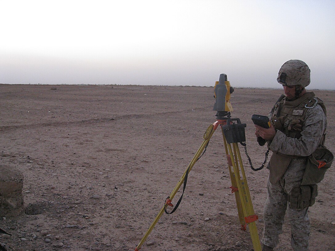 COMBAT OUTPOST GANNON II, Iraq (June 19, 2008) – Surveying the flat desert expanse, Cpl. Michael D. Decker, 22, Bad Ax, Mich., drafter, Engineer Company, Combat Logistics Battalion 6, 1st Marine Logistics Group, makes the proper calculations for engineers to build Combat Outpost Gannon II here, June 19. Approximately thirty days later on July 22, the same area had transformed into a fully operational outpost for Marines to conduct combat operations along the border. (Photo by Capt. Lauren S. Edwards)