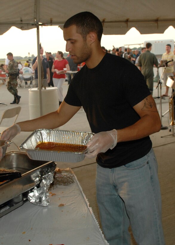 LANGLEY AIR FORCE BASE, Va. -- Airman 1st Class Jade Pina,1st Comptroller Squadron special actions technician, serves food at the VIP tent during AirPower over Hampton Roads June 20. Langley’s open house is an annual event that helps educate the public, increase recruiting and show appreciation to the local community. (U.S. Air Force photo/Airman 1st Class Aaron Johnson)