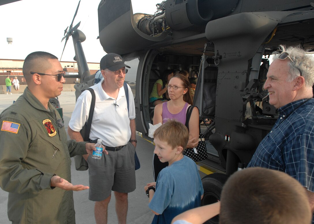 LANGLEY AIR FORCE BASE, Va. -- U.S. Army 1st Lt. Ben Hardman (Left), UH-60 Blackhawk pilot, explains the dangers of flying helicopters during June 20. He spoke to people at AirPower over Hampton Roads. Langley’s annual open house is an event that helps educate the public, increase recruiting and to show appreciation to the local community. (U.S. Air Force photo/Airman 1st Class Aaron Johnson)
