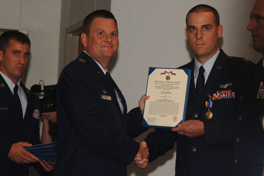 Captain Michael Engel from the 4th Expeditionary Special Operations Squadron Hurlburt Field Florida, is awarded the Single Mission Air Medal for extraordinary achievement while participating in aerial flight as an AC-130U crew, June 20, 2008. U.S. Air Force photo by SrA Emily Moore.