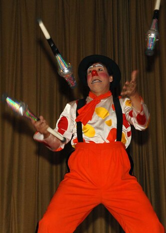 Luigi, a member of the Ringling Brothers and Barnum & Bailey Circus, juggles clubs during a performance for military families at the base theater on Nellis Air Force Base, Nev., June 20, 2008.The circus members performed the free show to bring joy to an audience of more than 400 military children and families. After the performance, audience members had the opportunity to record a video greeting that will be sent overseas to deployed Troops. (U.S. Air Force photo / Senior Airman Kasabyan D. Musal,)