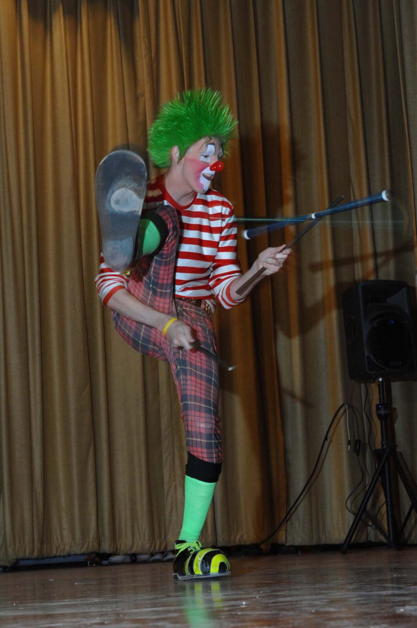 Crickett the clown twirls his juggling sticks during the Ringling Brothers and Barnum & Bailey Circus base theatre showcase in front of a crowd of military families, Nellis Air Force Base, Nev., June 20, 2008. The circus members performed the free show to bring joy to an audience of more than 400 military children and families. After the performance, audience members had the opportunity to record a video greeting that will be sent overseas to deployed Troops. (U.S. Air Force Photo by/Senior Airman Larry E. Reid Jr.)