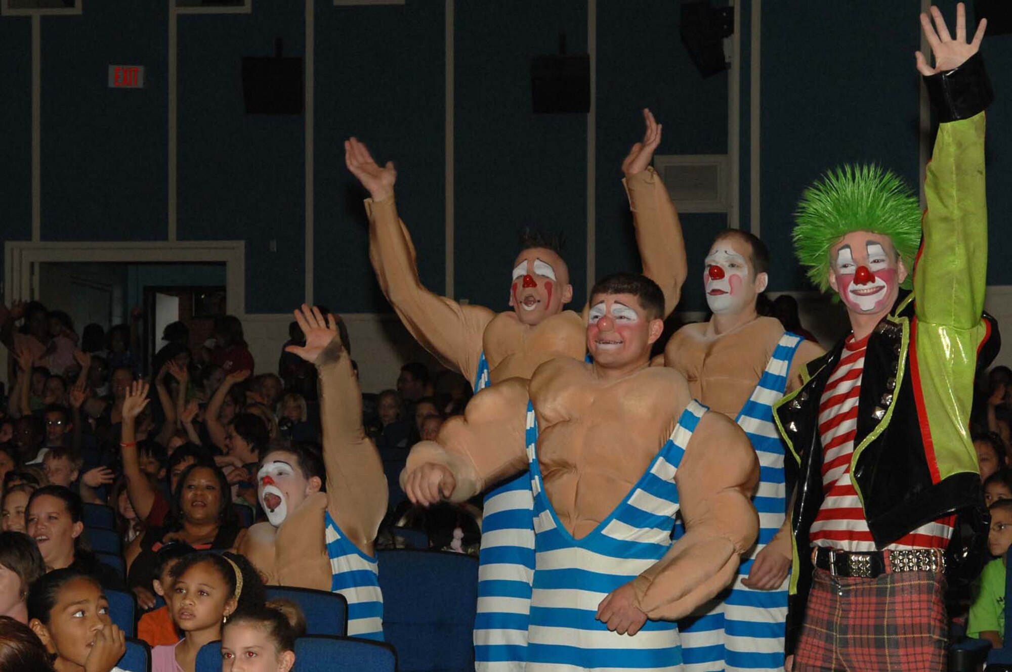 Members of the Ringling Brothers and Barnum & Bailey Circus join audience members in saying hello to deployed and remote family members during a performance for military families at the base theater on Nellis Air Force Base, Nev., June 20, 2008.  The circus members performed the free show to bring joy to an audience of more than 400 military children and families. After the performance, audience members had the opportunity to record a video greeting that will be sent overseas to deployed Troops. (U.S. Air Force photo / Senior Airman Kasabyan D. Musal,)
