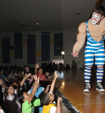Ben the clown selects volunteers from the crowd to assist him in a performance during the Ringling Brothers and Barnum & Bailey Circus base theatre showcase in front of a crowd of military families, Nellis Air Force Base, Nev., June 20, 2008. The circus members performed the free show to bring joy to an audience of more than 400 military children and families. After the performance, audience members had the opportunity to record a video greeting that will be sent overseas to deployed Troops. (U.S. Air Force Photo by/Senior Airman Larry E. Reid Jr.)