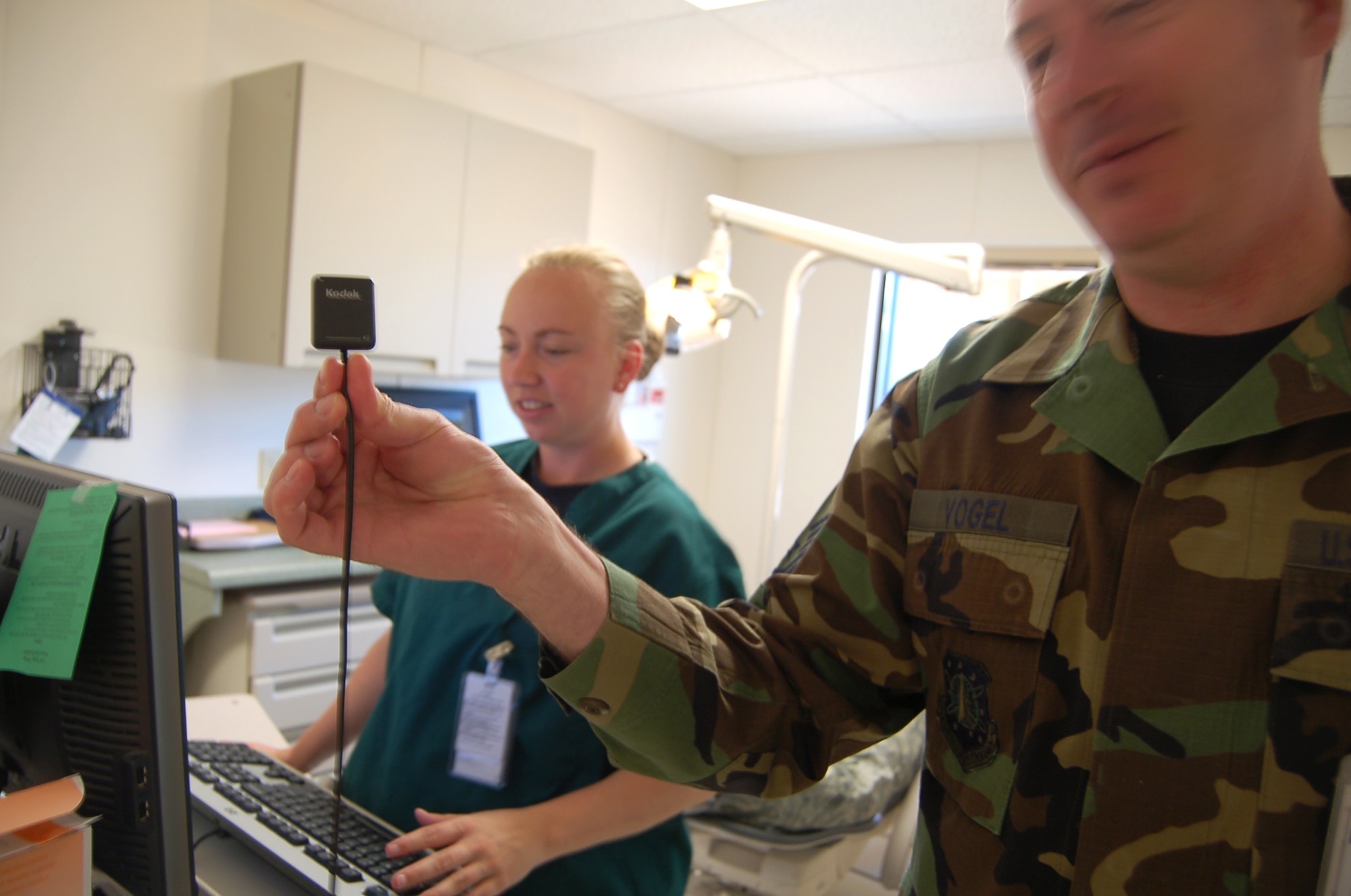 Senior Master Sgt. Richard Vogel, 21st Dental Squadron dental clinic superintendent, shows off the new digital sensors the clinic’s dentists use to take digital x-rays. The dental clinic’s x-ray system has gone completely digital, eliminating the old x-ray film system. (U.S. Air Force photo/Corey Dahl)