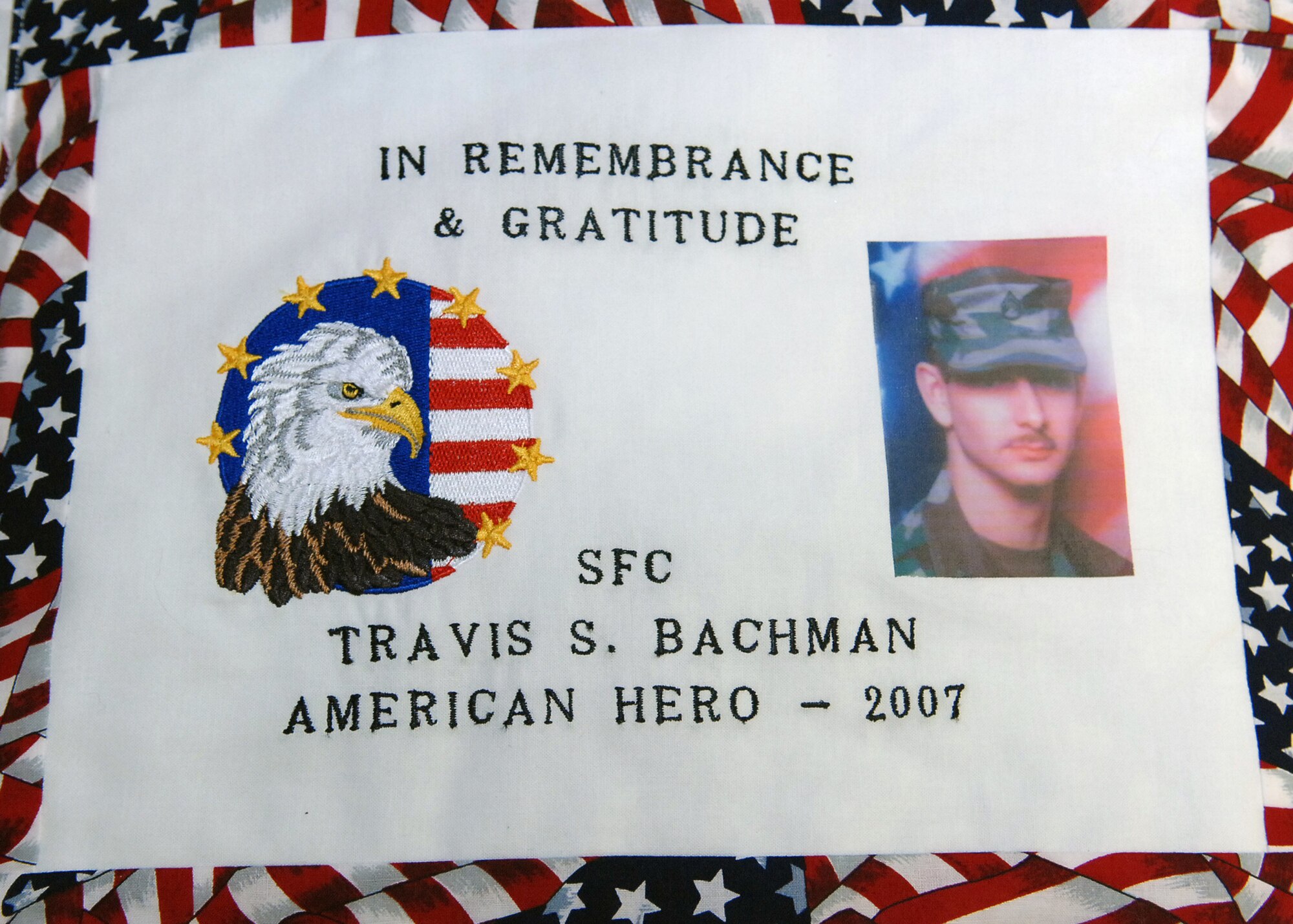 CANNON AIR FORCE BASE, N.M. -- Sgt.1st Class Travis Bachman is remembered by the Caprock Quilters who presented one of six quilts made in his honor to his parents, Connie and Rodney Bachman, of Garden City Kan. on June 20. The other five quilts were presented to each of his three children, wife Amber and aunt and uncle Linda and Rick Madera of Clovis, N.M. Sgt. 1st Class Bachman was killed by in improviesed explosive device in Iraq in Auust 2007. (Air Force photo by Airman 1st Class Danielle Martin)