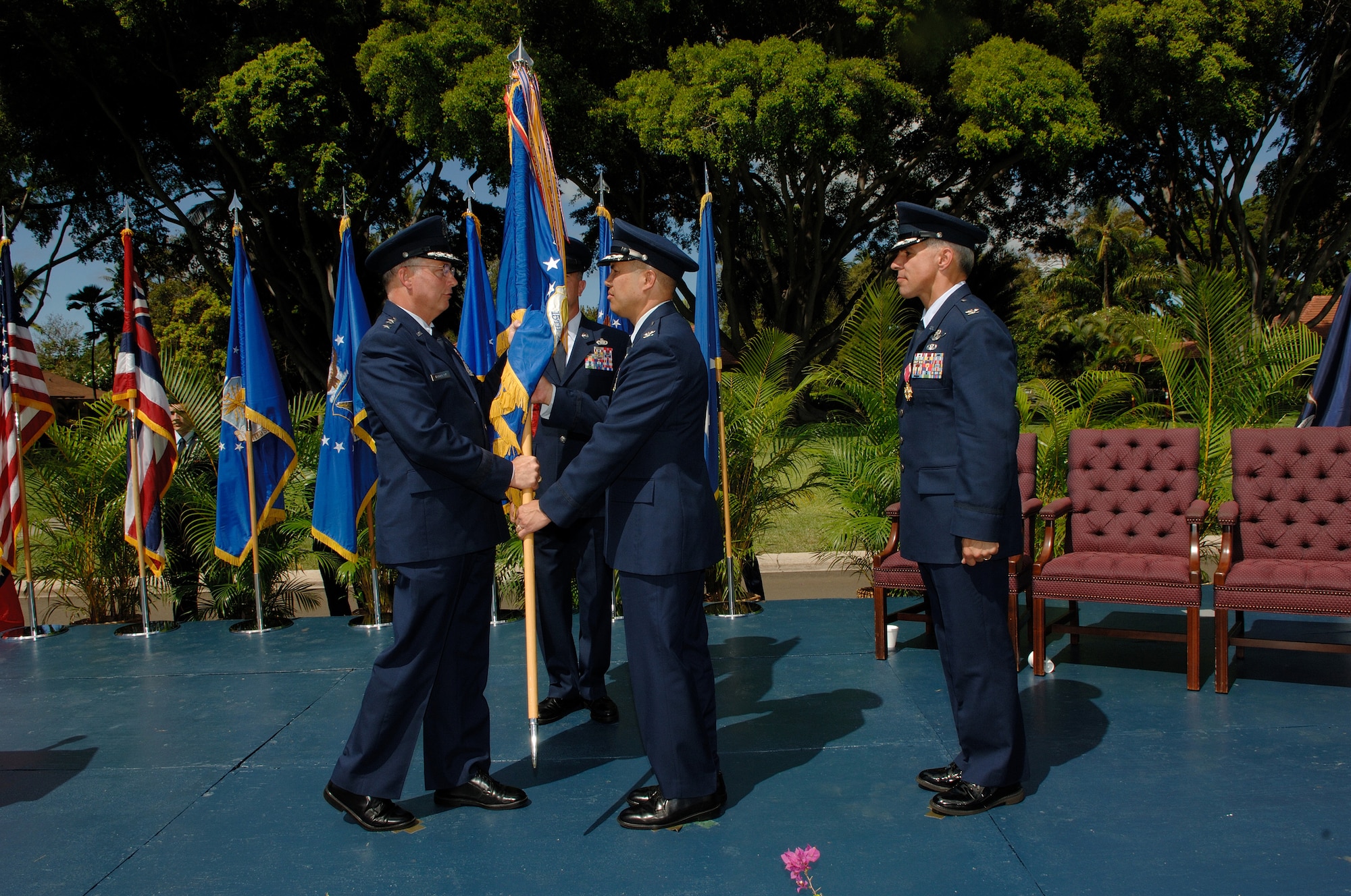 Col. Giovanni K. Tuck takes the 15th Airlift Wing Flag from Lt. Gen. Lloyd S. "Chip" Utterback, 13th Air Force commander during a change of command ceremony at the Freedom Tower Mall. Colonel Tuck took command of the 15th Airlift Wing June 20. (U.S. Air Force Photo/Mark Bates)