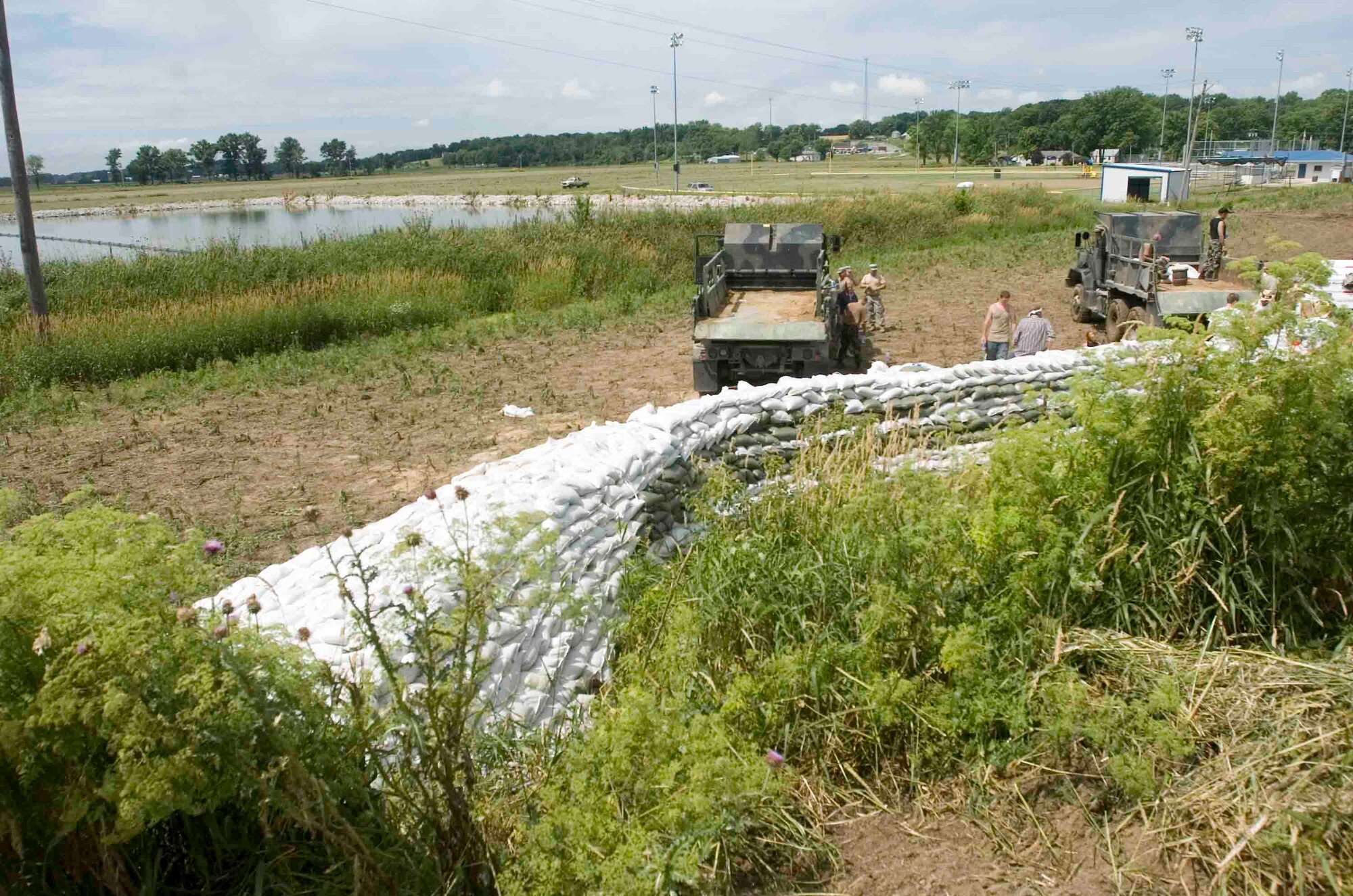 A wall of sand bags is used to secure a section of a levee near Winfield, Mo., June 20. Missouri Air National Guardsmen from the 131st Fighter Wing in St. Louis work together with Soldiers from the Missouri Army National Guard's 1140 Engineering Battalion out of Cape Girardeau, Mo., to help the city of Winfield. (U.S. Air Force photo/Staff Sgt. Desiree Palacios)