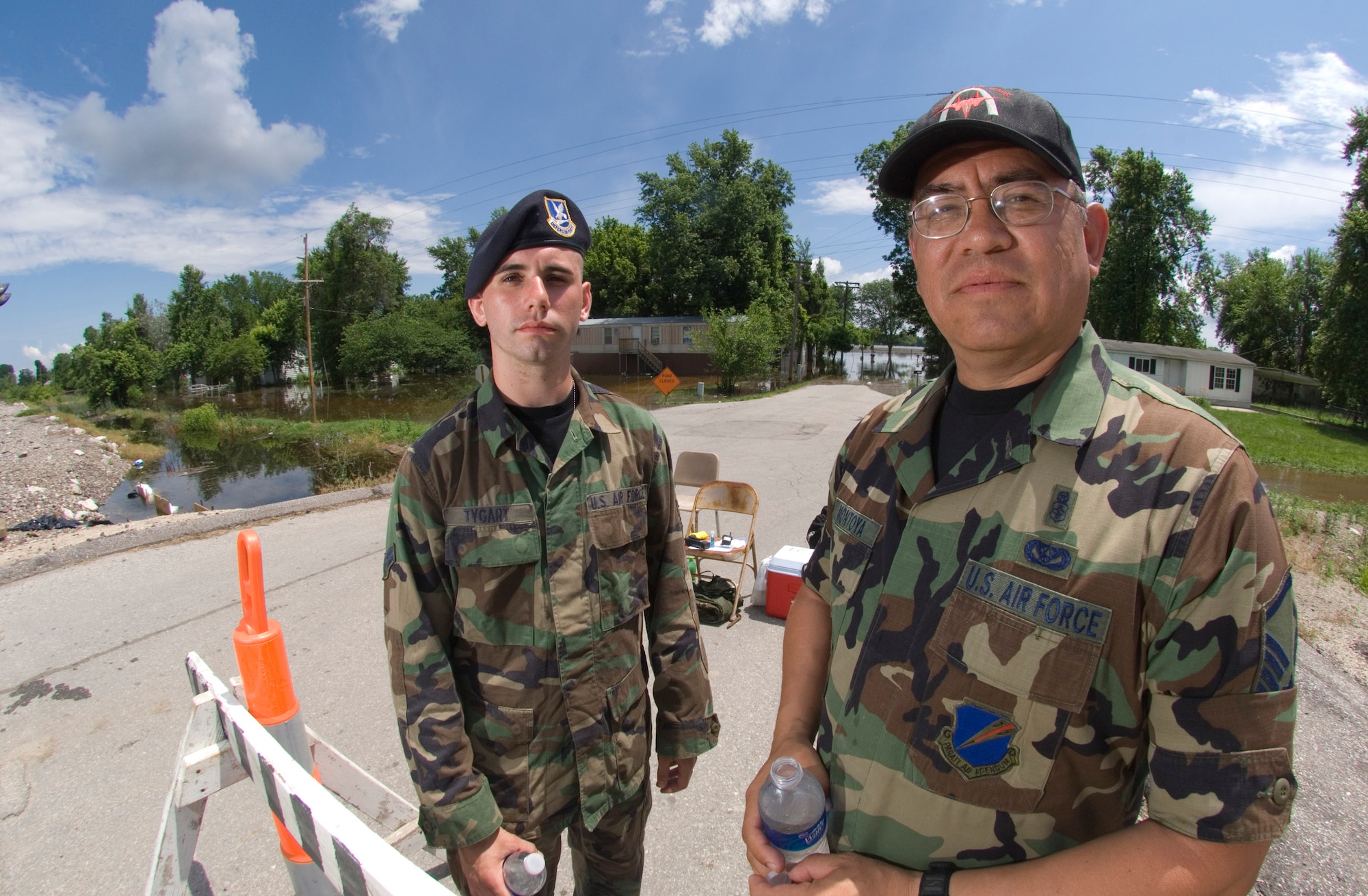 Master Sgt. Chris Montoga, right, and Airman First Class Jon Taggart man a checkpoint in Foley, Mo., June 20. Checkpoints manned by members of the Missouri Air National Guard are set up along a 30-mile stretch of the Mississippi River near Winfield, Mo. Air National guardsmen control access to flooded areas and provide a deterrent to would-be looters. Sergeant Montoga and Airman Taggart are both from the 131st Fighter Wing at Lambert Field, Mo.  (U.S. Air Force photo/Master Sgt Jack Braden)