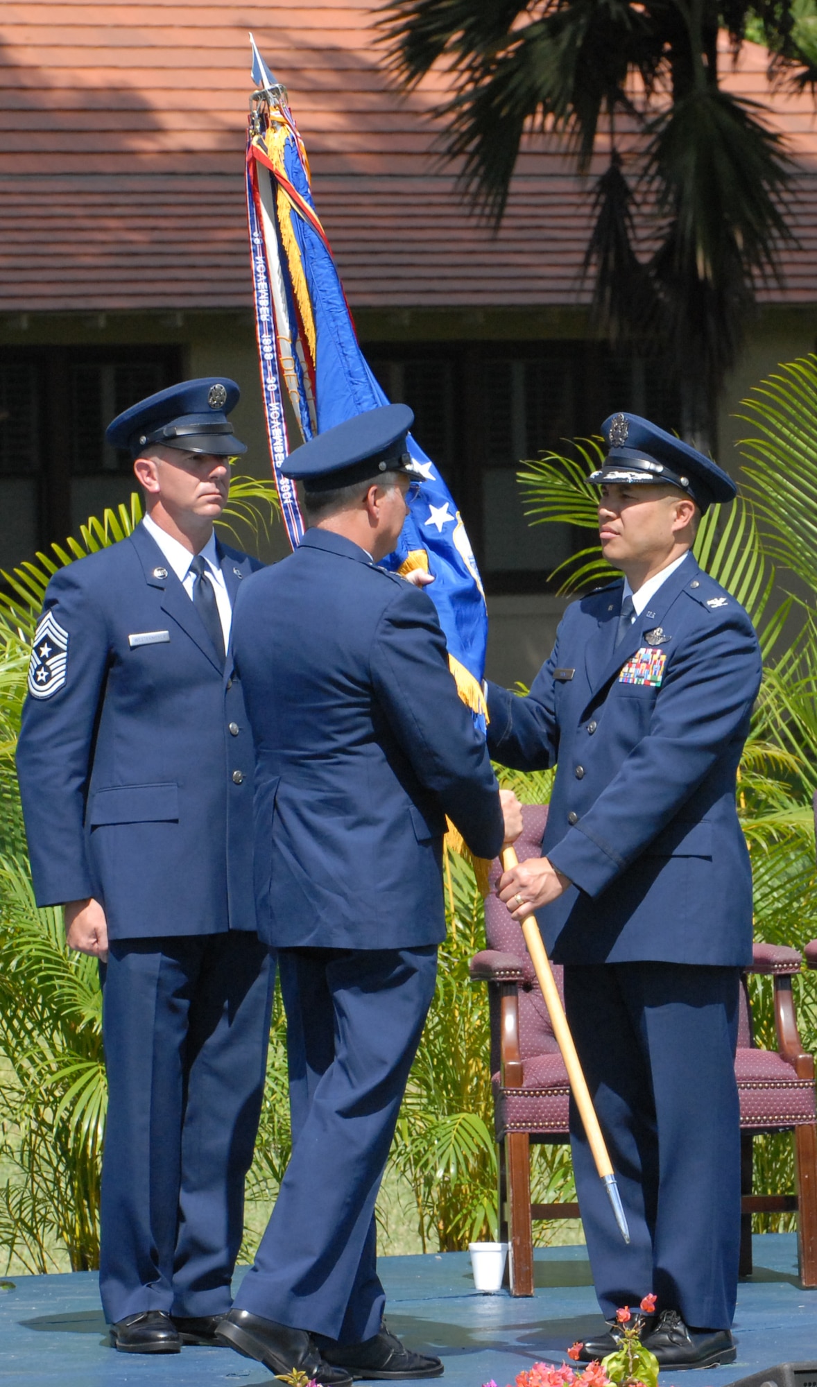 Lt. Gen. Loyd S. "Chip" Utterback, 13th Air Force commander, passes the 15th Airlift Wing Flag to Col. Giovanni Tuck, during a Change of Command ceremony June 20 at the Freedom Tower Mall. (U.S. Air Force Photo by Tyler Hatfield)