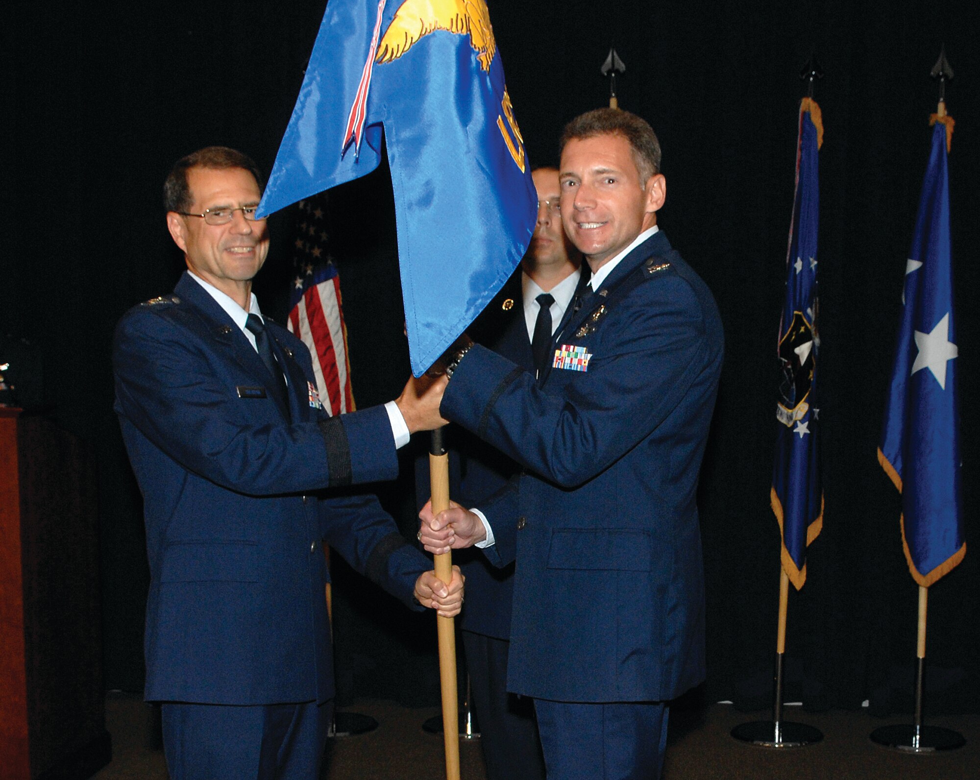 Col. Gary Henry accepts the Launch and Range Systems Wing guidon from AFSPC/SMC Commander, Lt. Gen. John T. 'Tom' Sheridan signifying his acceptance of command as the new commander of AFSPC Space and Missile Systems Center Launch and Range Systems Wing. Colonel Henry, formerly vice commander of the Space Superiority Systems Wing. (photo by Stephen Schester)