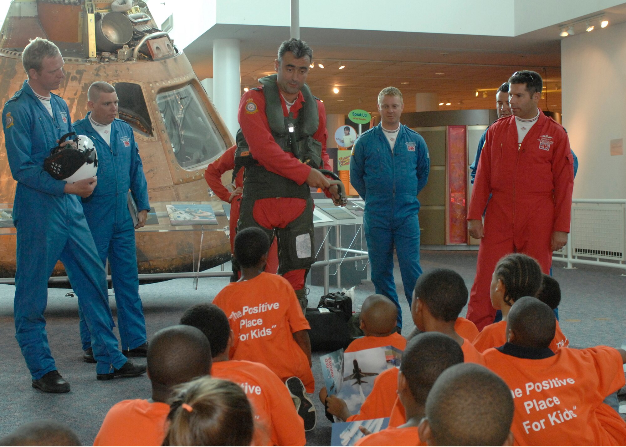 LANGLEY AIR FORCE BASE, Va. -- Graham Duff, British Royal Air Force Red Arrows pilot and squadron leader, demonstrates putting on his flight gear at the Virginia Air and Space Center in front of children from the Suffolk YMCA June 20. The Red Arrows are here for AirPower over Hampton Roads. Langley’s annual open house is an event that helps educate the public, increase recruiting and to show appreciation to the local community. (U.S. Air Force photo/Airman 1st Class Aaron Johnson)  