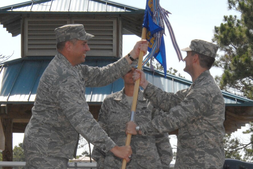 Col. Mike Smietana, 1st Special Operations Mission Support Group commander, presents the 1st Special Operations Force Support Squadron guidon to Maj. Damon Menendez during a ceremony June 20. The ceremony officially marked the merger of the 1st Special Operations Services Squadron and the 1st Special Operations Mission Support Squadron, and the creation of the 1st Special Operations Force Support Squadron. Maj. Damon Menendez, former 1st SOMSS commander, will command the new squadron. (U.S. Air Force photo/Senior Airman Stephanie Jacobs)