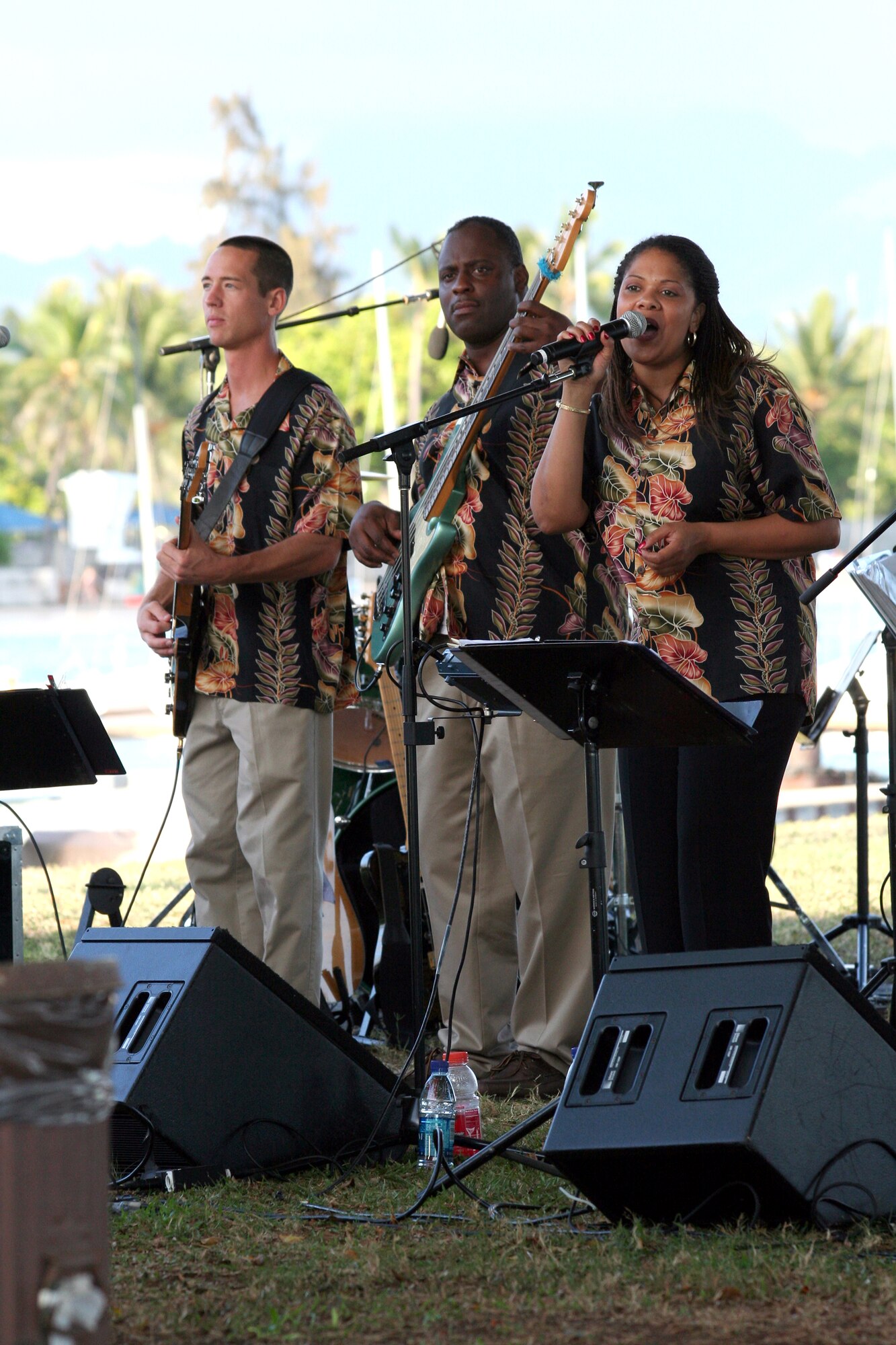 HICKAM AIR FORCE BASE, Hawaii – U.S. Air Force Staff Sergeant John Kukan, guitarits, Staff Sergeant Terry J. Grace, bass, and Staff Sergeant Tamiko Boone, vocalist,, members of the Air Force Band of the Pacific, ‘Hana Hou’, perform here May 18 during a concert hosted by Col. J.J. Torres, 15th Airlift Wing commander.  Hana Hou’s performances delight military and civilian audiences throughout Hawaii and the Pacific.  (US Air Force photo/ Master Sgt. Cherie McNeill)  