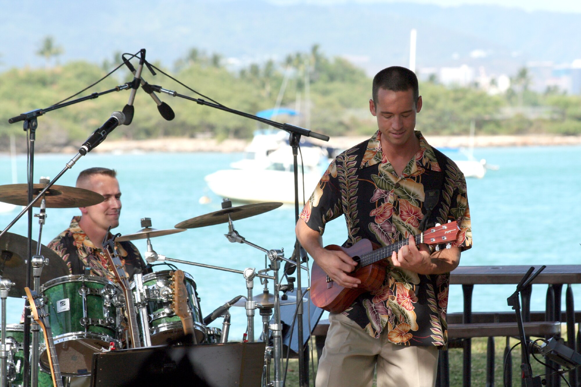 HICKAM AIR FORCE BASE, Hawaii – U.S. Air Force Staff Sergeant David E. Vittetoe, drummer  and Staff Sergeant John Kukan, guitarist, members of the Air Force Band of the Pacific, ‘Hana Hou’, perform here May 18 during a concert hosted by Col. J.J. Torres, 15th Airlift Wing commander.  Hana Hou’s performances delight military and civilian audiences throughout Hawaii and the Pacific.  (US Air Force photo/ Master Sgt. Cherie McNeill)  