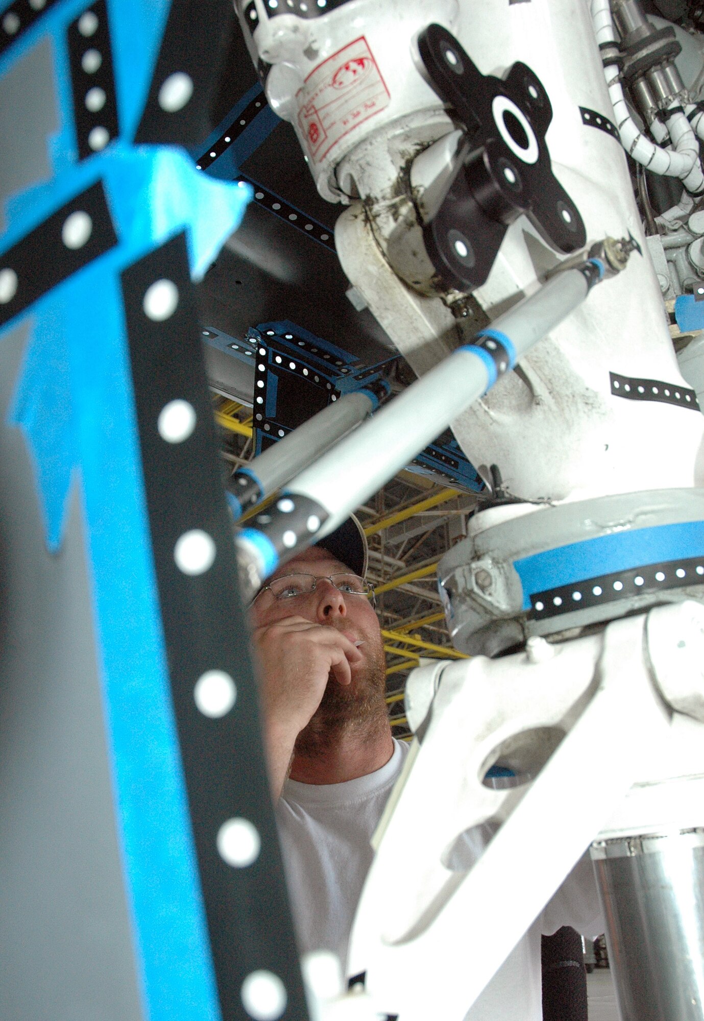 David Senter places reflective dots on the A-10C Thunderbolt II frame, which will later be photographed using a handheld camera. Next, using Virtual Surveillance Target Attack Radar System technology, a 3-D image of the aircraft will be generated. This will help engineers outfit the A-10 for smart weapons. Mr. Senter is a 46th Seek Eagle equipment specialist. (U.S. Air Force photo/Staff Sgt. Stacia Zachary) 