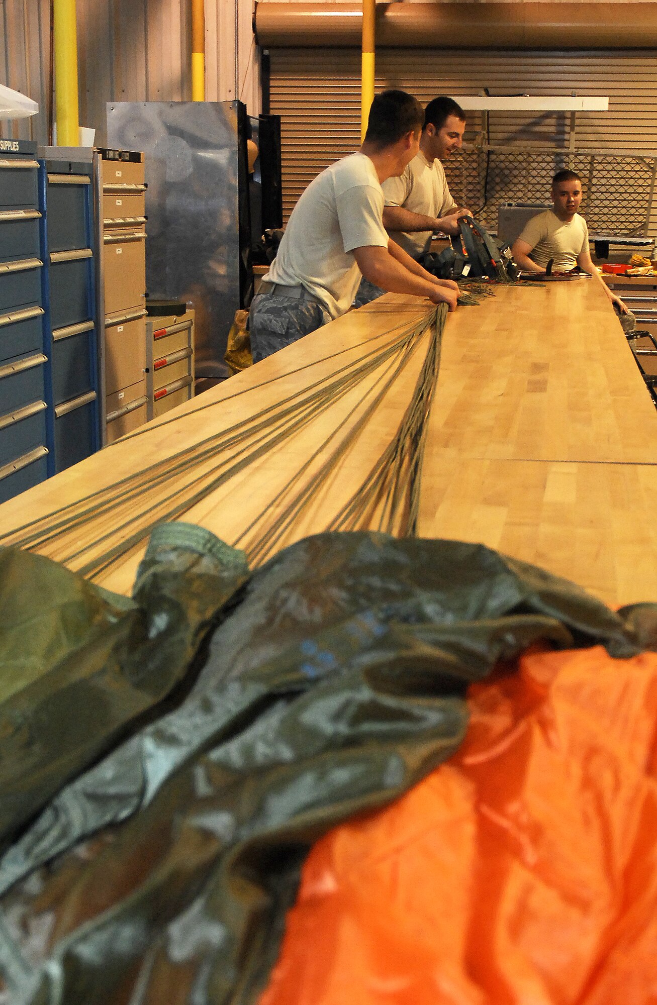 CANNON AIR FORCE BASE, N.M. --  Airmen from the Aircrew Flight Equipment shop  prepare the BA-22 back automatic parachute for inspection June 19.  Airmen from the Aircrew Flight Equipment shop issue and maintain survival equipment items and, when necessary, repair and replace them.  (U.S. Air Force photo/Senior Airman Liliana Moreno)