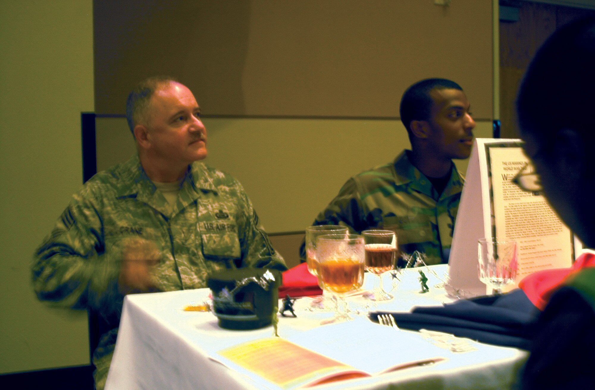 Chief Master Sgt. David Crane, 17th Training Group, chief enlisted manager, bangs his spoon on the table in appreciation during the 17th Training Wing Joint Enlisted Dining-In June 12.  Clapping is forbidden at dinings-in, so participants use their spoons in lieu of applause. (U.S. Air Force photo by Senior Airman Stephen Musal)