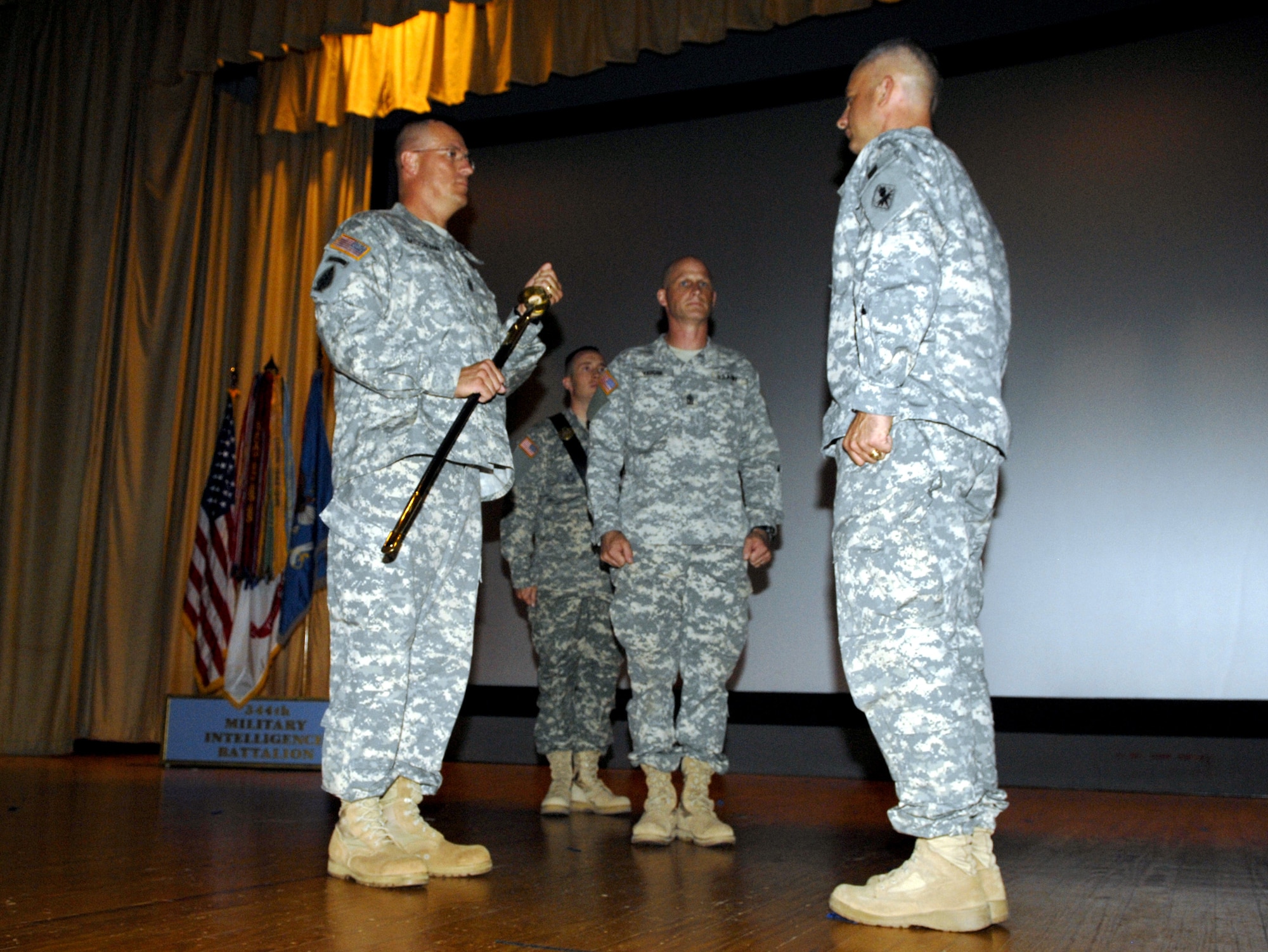 Former 344th Military Intelligence Battalion commander Lt. Col. Kemp Chester bestows responsibility on Army Command Sgt. Maj. Dan McGraw June 17. (U.S. Air Force photo by Senior Airman Kamaile Chan)