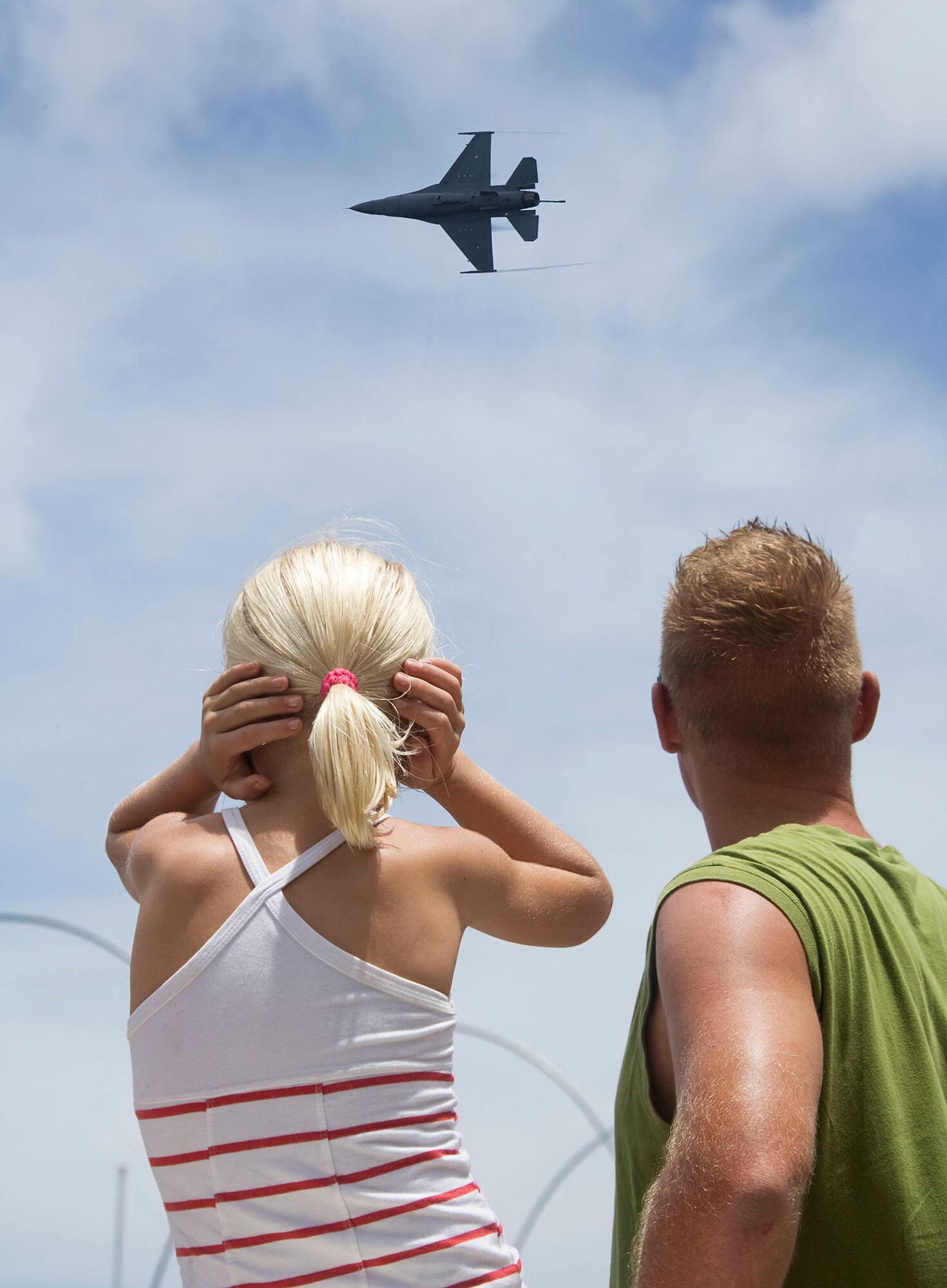 Curacao, Netherlands Antilles -- A local child covers her ears as the Viper East demonstration team performs over a bay in Curacao, Netherlands Antilles.  The demonstration, flown by Capt. George Clifford, an F-16 demo pilot from Shaw Air Force Base, South Carolina, was the demonstration team's first overseas demonstration, first over water and first demo in the Caribbean this show season.  Viper East joined an Air Forces Southern effort to augment "Dutch Navy Days," a celebration put on every three years by the Dutch military to honor their naval heritage and partnership with the people of Curacao. (Photo by Peter Bijpost)