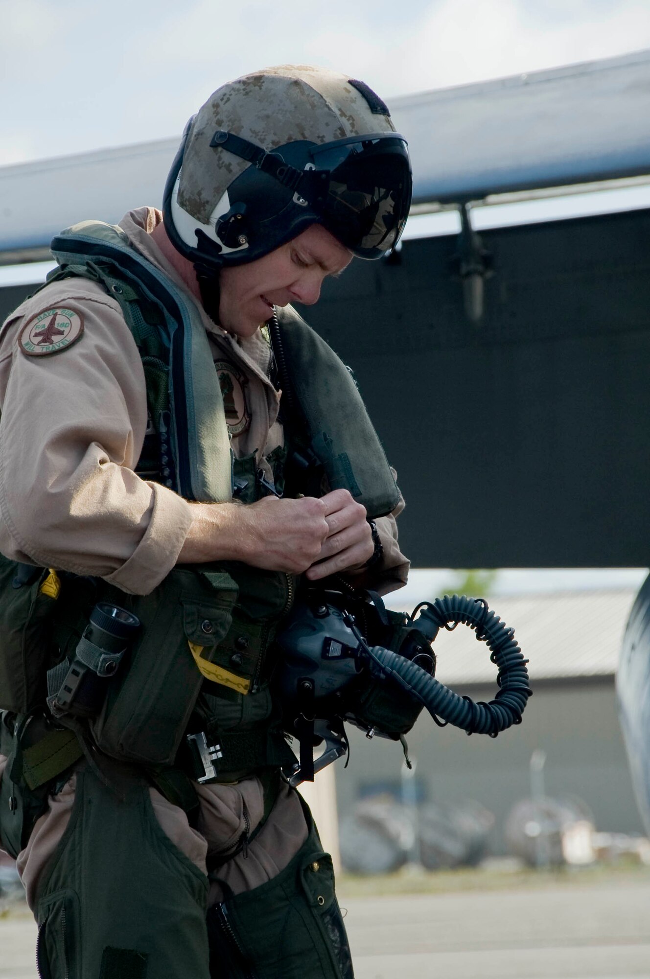 EIELSON AIR FORCE BASE, Alaska --Capt. Bryan Youngers from Miramar Naval Air Station adjusts his flight equipment prior to takeoff June 19, 2008. Captain Youngers is participating in RED FLAG- Alaska Alaska 08-3 a series of Pacific Air Forces commander-directed field training exercises for U.S. forces, provides joint offensive counter-air, interdiction, close air support, and large force employment training in a simulated combat environment.  (U.S. Air Force photo by Airman 1st Class Christopher Griffin)(RELEASED)