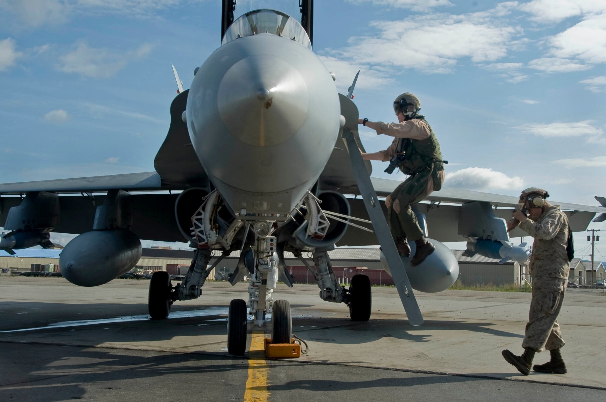 EIELSON AIR FORCE BASE, Alaska --Capt. Bryan Youngers from Miramar Naval Air Station adjusts climbs up into an F-18 Hornet June 19, 2008. Captain Youngers is participating in RED FLAG- Alaska Alaska 08-3 Eielson Air Force Base and Elmendorf Air Force Base are the home of Red Flag-Alaska, a realistic, 10-day air combat training exercise held up to four times a year. Each RED FLAG-Alaska exercise is a multi-service, multi-platform coordinated, combat operations exercise and corresponds to the designed operational capability of participating units.  (U.S. Air Force photo by Airman 1st Class Christopher Griffin)