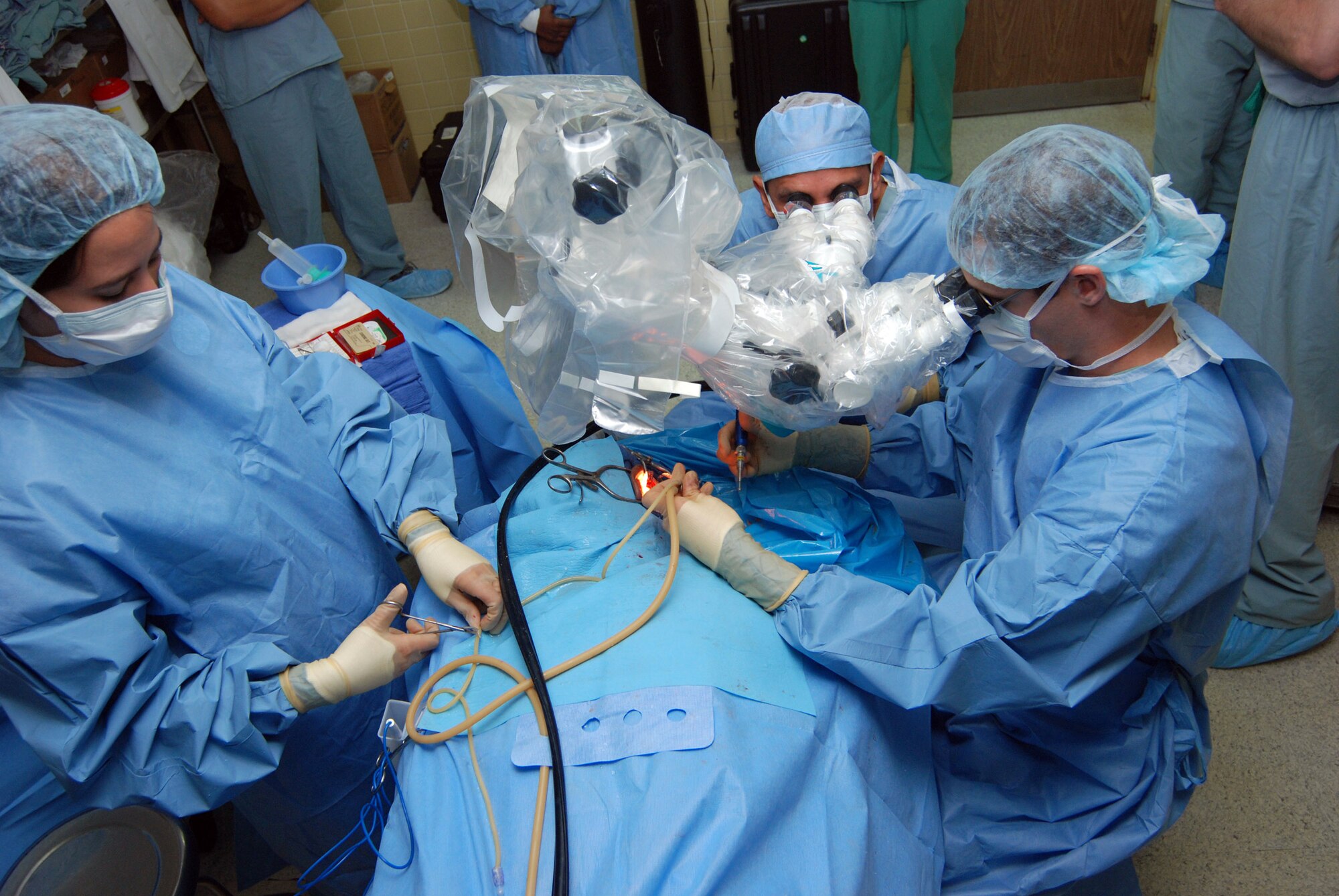 A surgical team from Wilford Hall Medical Center, San Antonio, Texas, performs ear surgery on a patient June 17 at Hospital Escuela in Tegucigalpa, Honduras. A 14-person team from WHMC spent two weeks performing ear, nose and throat procedures, as well as providing hearing tests and hearing aid fittings in Honduras. (U.S. Air Force photo/Tech. Sgt. John Asselin)