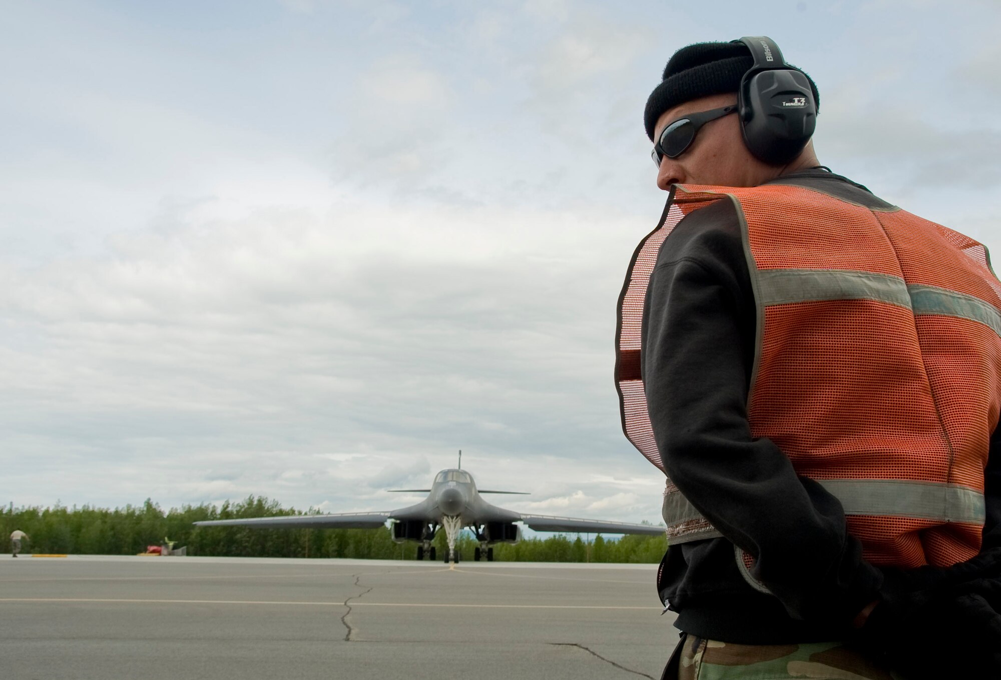 EIELSON AIR FORCE BASE, Alaska -- Staff Sgt. Jeffrey Martinez a crew chief from Dyess Air Force Base checks his surroundings before marshaling a B-1 Lancer June 18, 2008. The Lancer serves as the supersonic-capable component of the United States Air Force's long-range bomber force. The B-1's from Dyess are participating in RED FLAG-Alaska 08-3; these exercises are conducted on the Pacific Alaskan Range Complex with air operations flown out of Eielson and Elmendorf Air Force bases in Alaska.   (U.S. Air Force photo by Airman 1st Class Christopher Griffin)