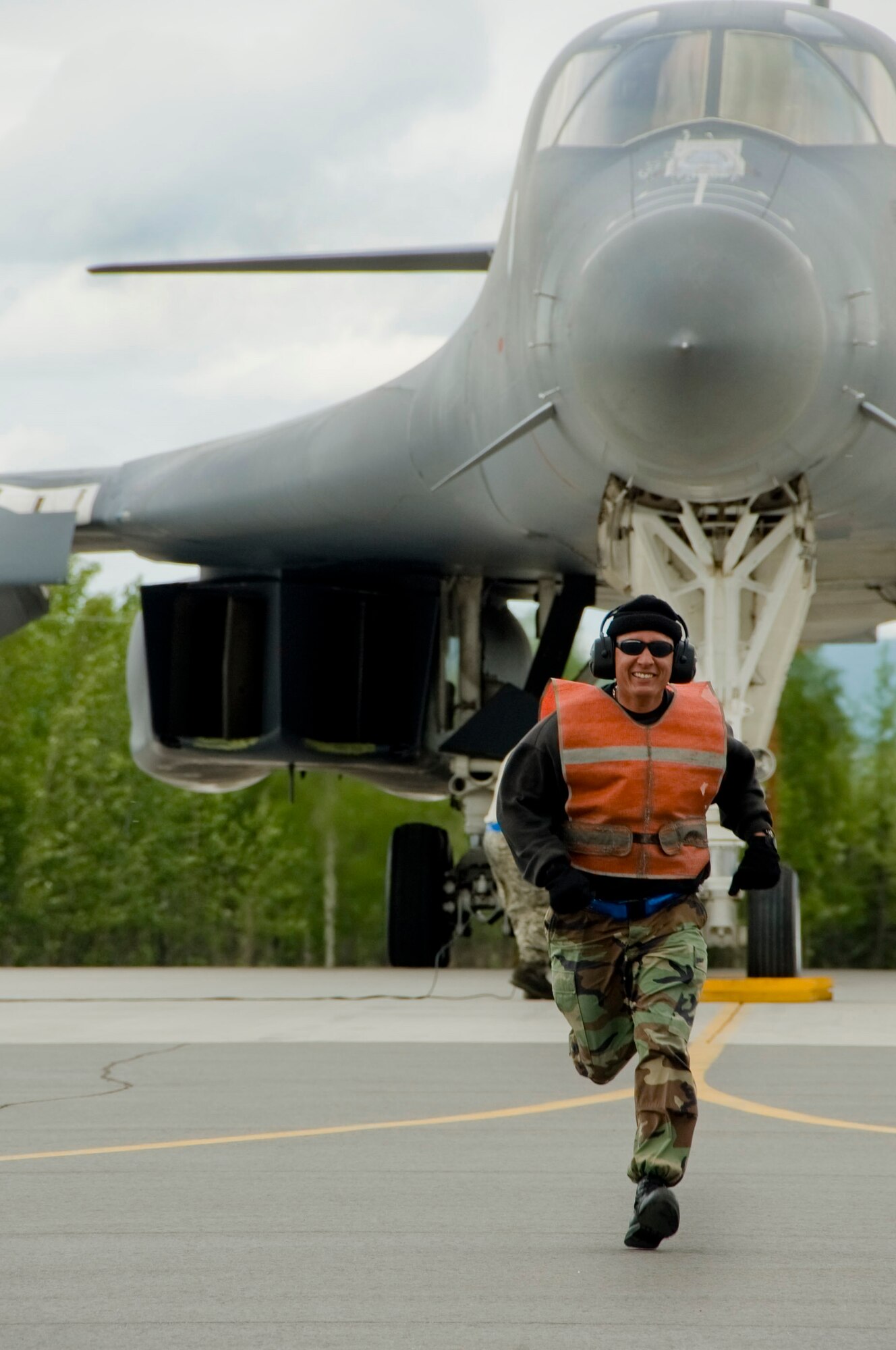 EIELSON AIR FORCE BASE, Alaska --Staff Sgt. Jeffrey Martinez a crew chief from Dyess Air Force Base runs down the Eielson flightline to prepare to marshal a B-1 Lancer June 18, 2008. The Lancer serves as the supersonic-capable component of the United States Air Force's long-range bomber force. The B-1's from Dyess are participating in RED FLAG-Alaska 08-3, a series of Pacific Air Forces commander-directed field training exercises for U.S. forces, provides joint offensive counter-air, interdiction, close air support, and large force employment training in a simulated combat environment.  (U.S. Air Force photo by Airman 1st Class Christopher Griffin)
