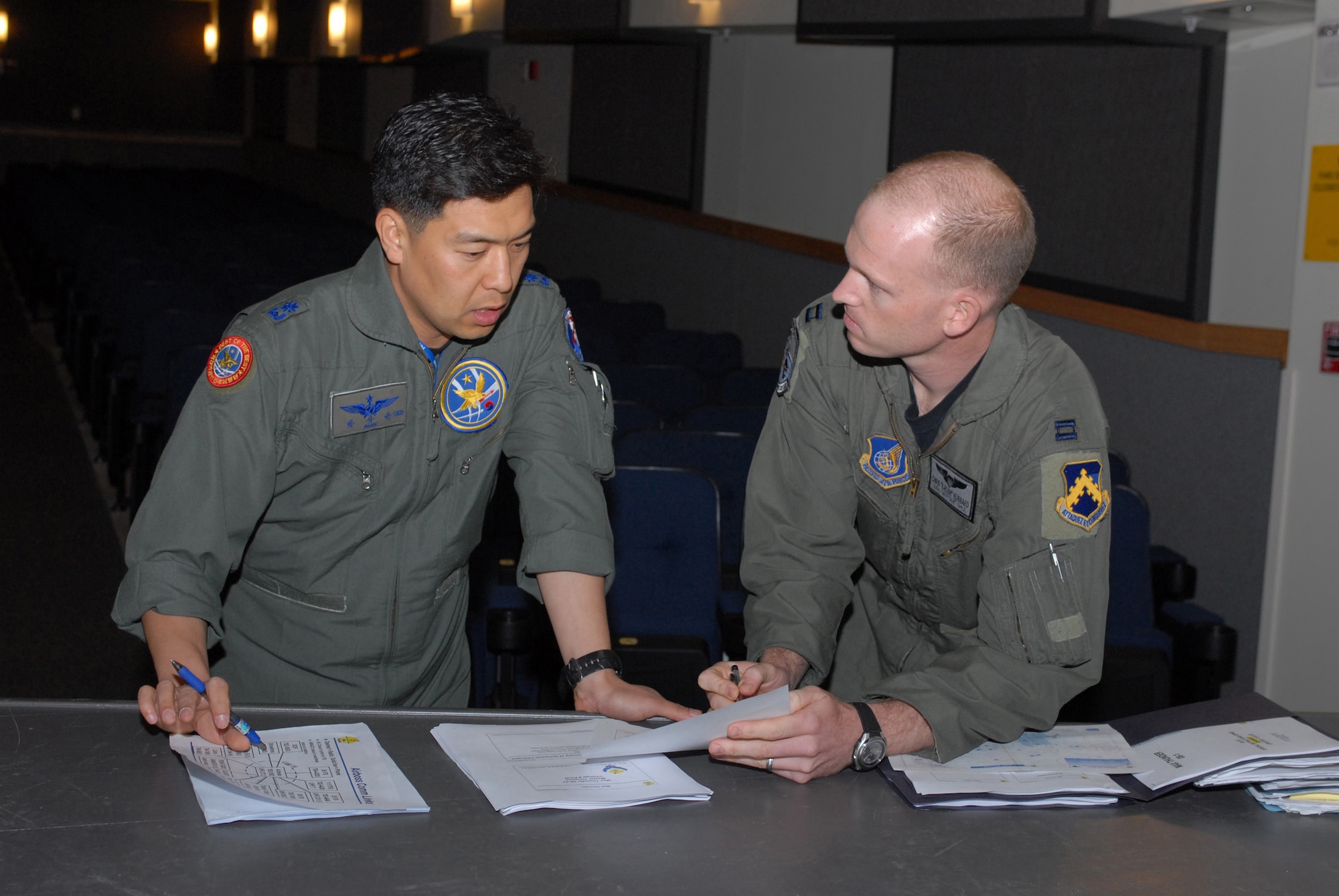 South Korea air force Maj. Sang-Gyoon Park discusses the Exercise Max Thunder itinerary with Capt. Chris Hubbard,  here June 16 at Kunsan Air Base, South Korea. Max Thunder is a bi-lateral training exercise between U.S. and Korean Airmen used to strengthen joint operations and sharpen warfighting skills. Major Park is a pilot with the 11th Fighter Wing and Captain Hubbard is an 8th Operations Group pilot. (U.S. Air Force photo/Senior Airman Angela Ruiz) 