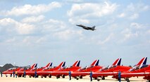An F-15 Eagle flies above the Royal Air Force Aerobatic Team, The Red Arrows, June 18 at Langley Air Force Base, Va. The Red Arrows will perform during AirPower over Hampton Roads, the Langley AFB airshow, which is scheduled for June 20 to 22. (U.S. Air Force photo/Airman 1st Class Aaron Johnson) 