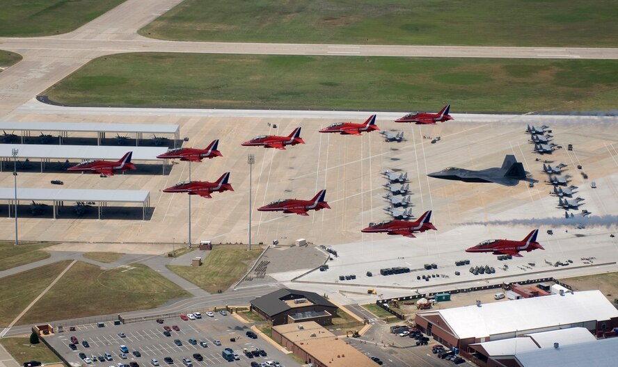 Maj. Paul Moga flies in formation in an F-22 Raptor with the Royal Air Force Aerobatic Team, The Red Arrows, during an afternoon practice flight June 18 at Langley Air Force Base, Va. The aircraft will perform at AirPower over Hampton Roads, the Langley AFB airshow, which is scheduled for June 20 to 22. Major Moga is an F-22 Demonstration Team pilot. (U.S. Air Force photo/Staff Sgt. Samuel Rogers) 