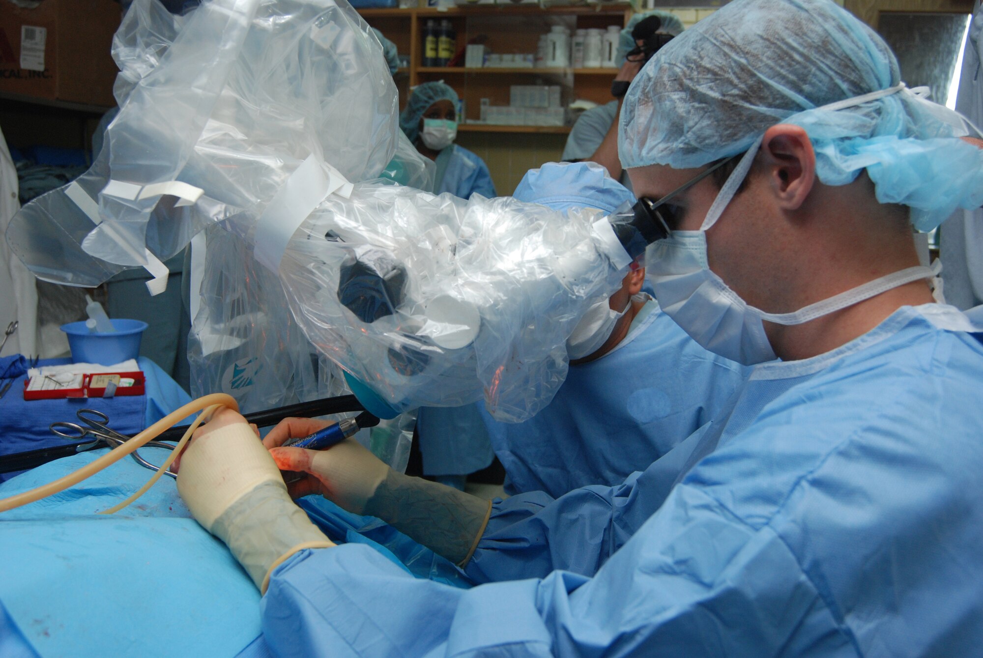 Capt. (Dr.) Luke Arnholt, and ENT surgeon from Wilford Hall Medical Center, San Antonio, Texas, performs ear surgery on a patient June 17 at Hospital Escuela in Tegucigalpa, Honduras. The 14-person team from WHMC did more than 240 patient evaluations and more than 40 surgeries during the two-week visit to the hospital. (U.S. Air Force photo by Tech. Sgt. John Asselin) 