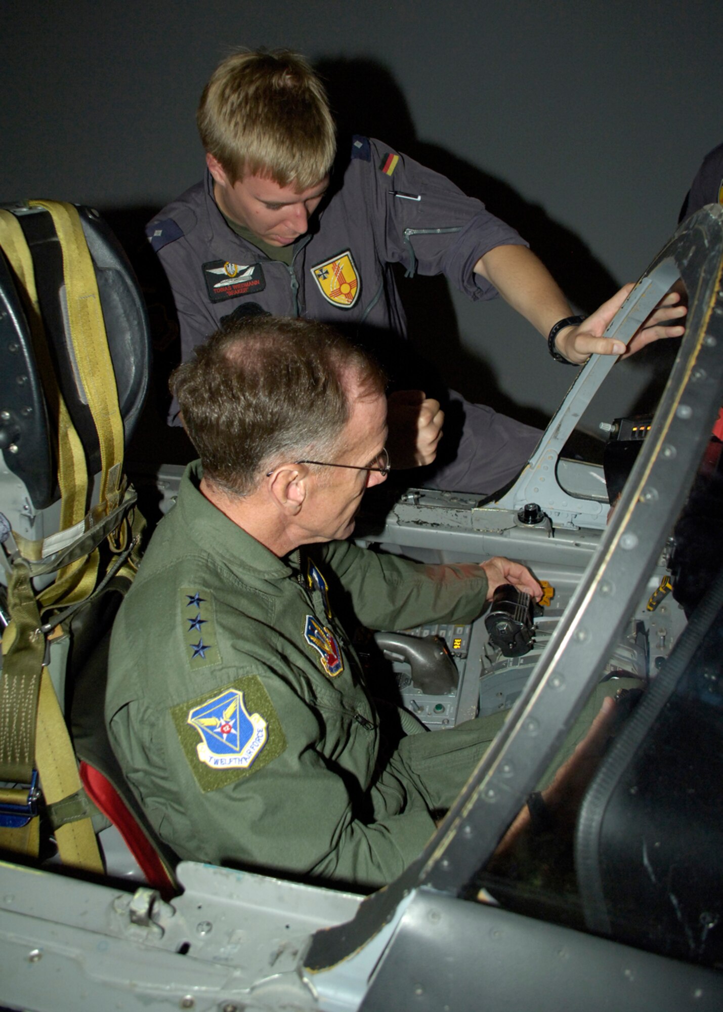 Capt. Tobias Wiedmann, German Air Force pilot, instructs Lt. Gen. Norman R. Seip,12th Air Force commander, on how to operate the Tornado during his visit to Holloman AFB, N.M., June 17. General Seip was given the opportunity to go through there Tornado simulator training. (U.S. Air Force photo/Airman 1st Class Michael Means)