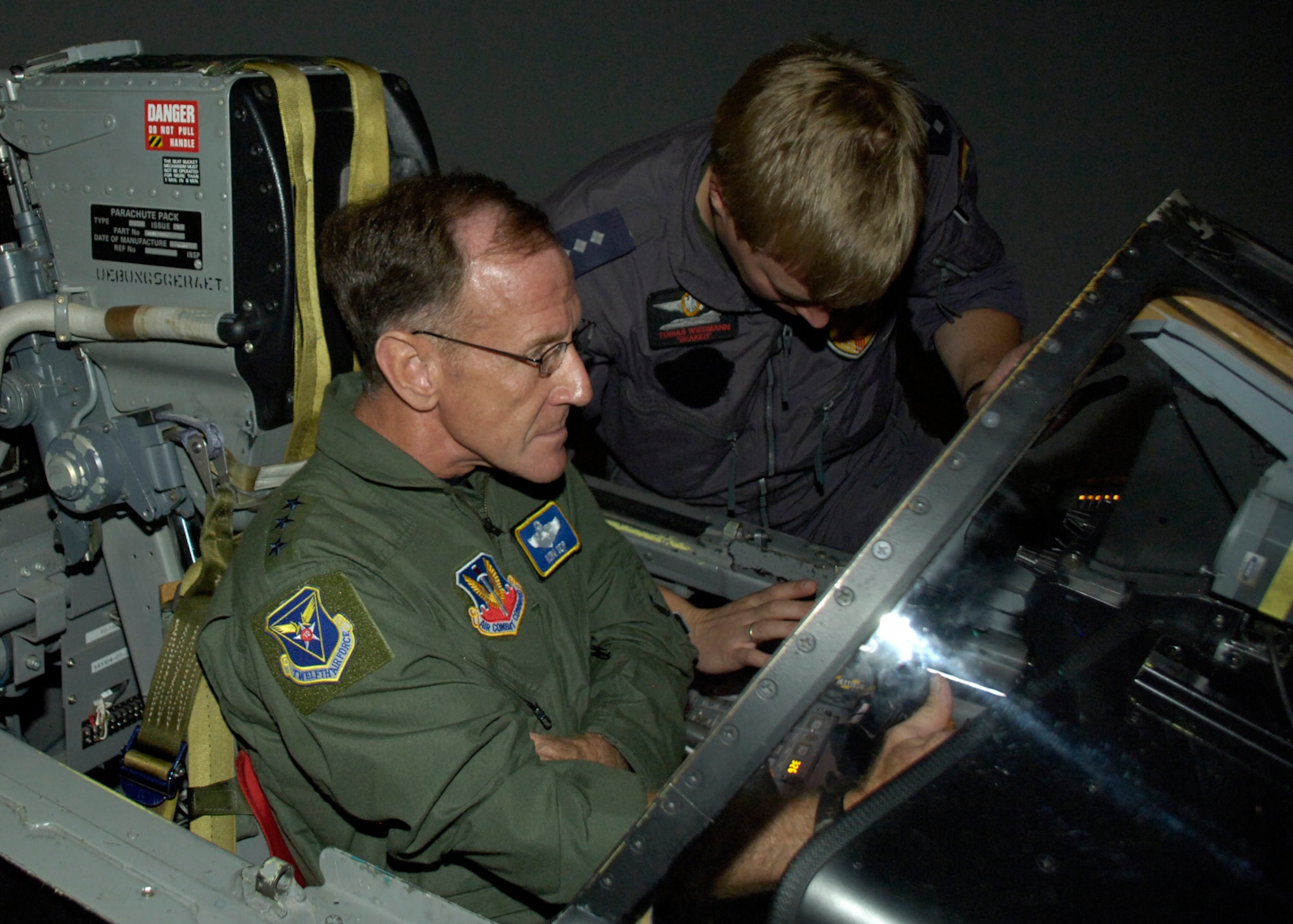 Capt. Tobias Wiedmann, German Air Force pilot, instructs Lt. Gen. Norman R. Seip,12th Air Force commander, on how to operate the Tornado during his visit to Holloman AFB, NM, June 17. Gen. Seip was given the opportunity to go through there Tornado simulator training. (U.S. Air Force photo/Airman 1st Class Michael Means)