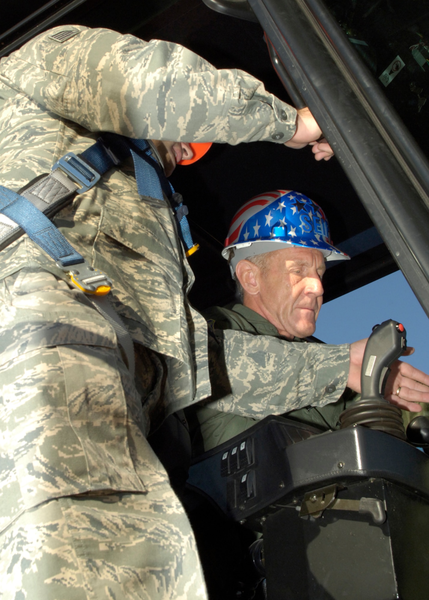 Tech. Sgt. Brian Butler, 49th Materiel Maintenance Support Squadron, shows Lt. Gen. Norman R. Seip,12th Air Force commander, how to operate a hyster during his visit to Holloman AFB, N.M., June 17. The hyster is able to lift cargo weighing up to 100K. (U.S. Air Force photo/Airman 1st Class Michael Means)