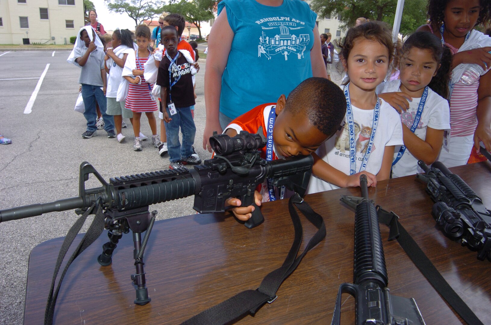 Damani Thomas, 6, inspects an M4 Carbine during Operation FLAGS. (U.S. Air Force photo by David Terry)