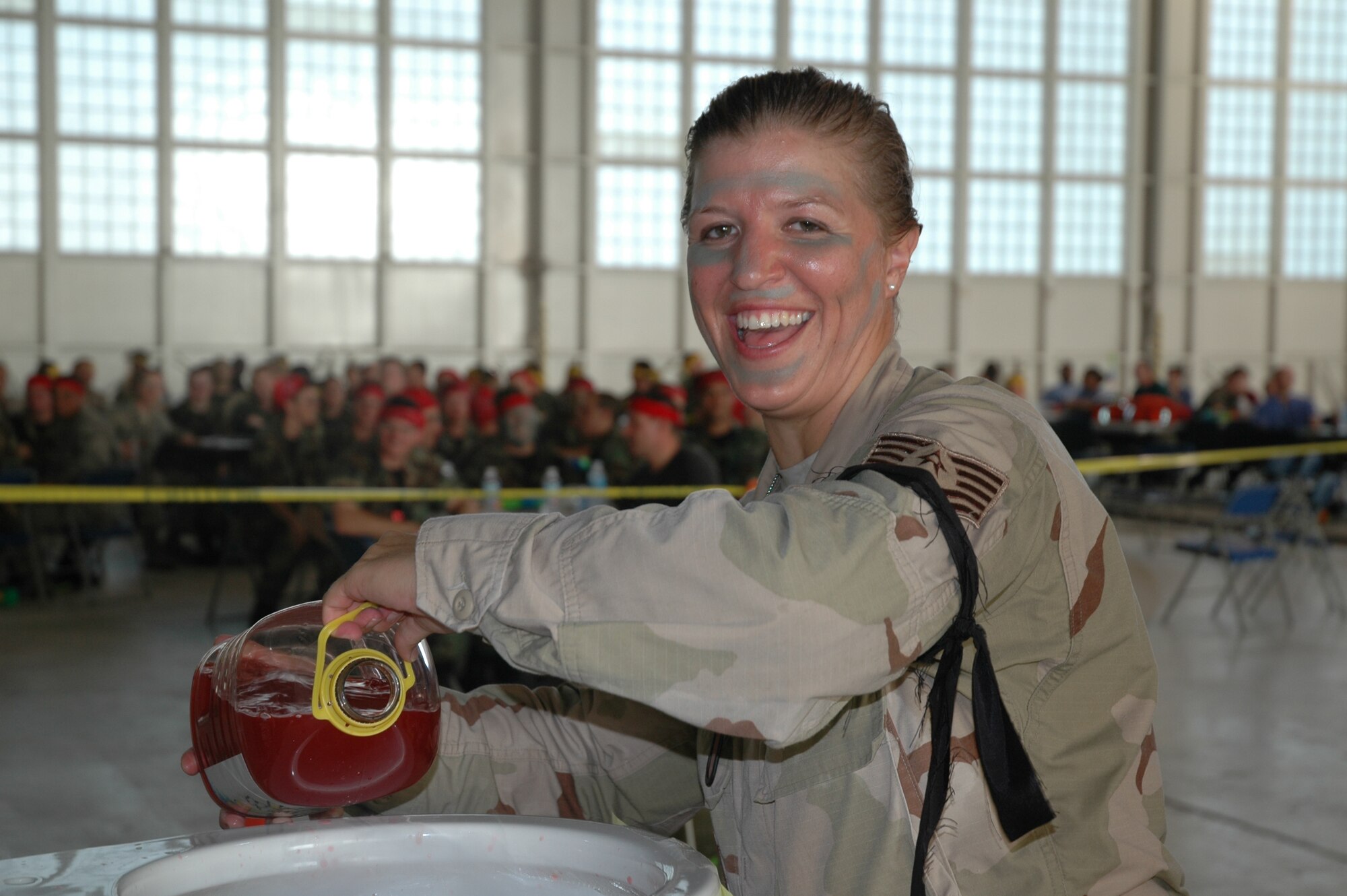 More than 200 people turned out Friday night to take over an entire hangar for the Patrick Air Force Base/Cape Canaveral Air Force Station Combat Dining-In. The night was marked by camaraderie, water balloons, and a speech from retired Brig. Gen. Steve Ritchie, the only ace from the Vietnam War.

Tech. Sgt. Dawn Wolfe is full of glee as she prepares the fearsome grog bowl. Commit any infraction, and the guilty party must run the obstacle course to the bowl and drink.
(U.S. Air Force photo by Airman 1st Class David Dobrydney)