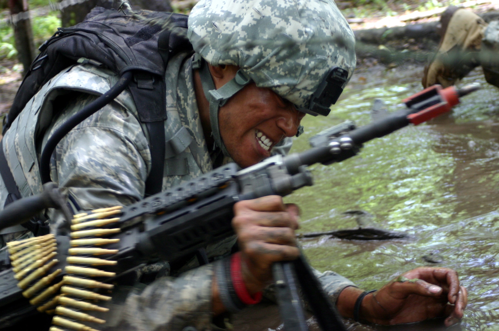 Airman 1st Class Bayomi Gholston, 60th Security Forces Squadron, Travis AFB, Calif., low crawls through the mud during Phoenix Warrior Training 08-5 June 19 at Fort Dix, N.J. The class, Combat First Aid Training, was held during day three of the 10-day course. Specifically designed for security forces members, the course is used as pre-deployment training. (U.S. Air Force photo/Airman 1st Class Rebekah Phy)