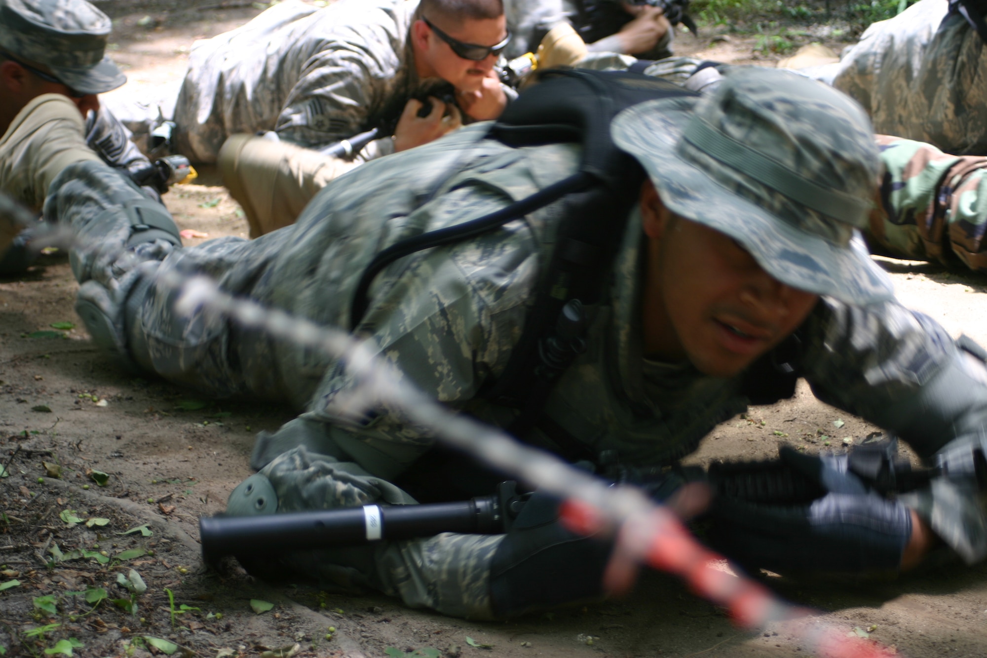 Airman 1st Class Claude Thompson, 60th Security Forces Squadron, Travis AFB, Calif., low crawls during Phoenix Warrior Training 08-5 June 19 at Fort Dix, N.J. The class, Combat First Aid Training, was held during day three of the 10-day course. Specifically designed for security forces members, the course is used as pre-deployment training. (U.S. Air Force photo/Airman 1st Class Rebekah Phy)