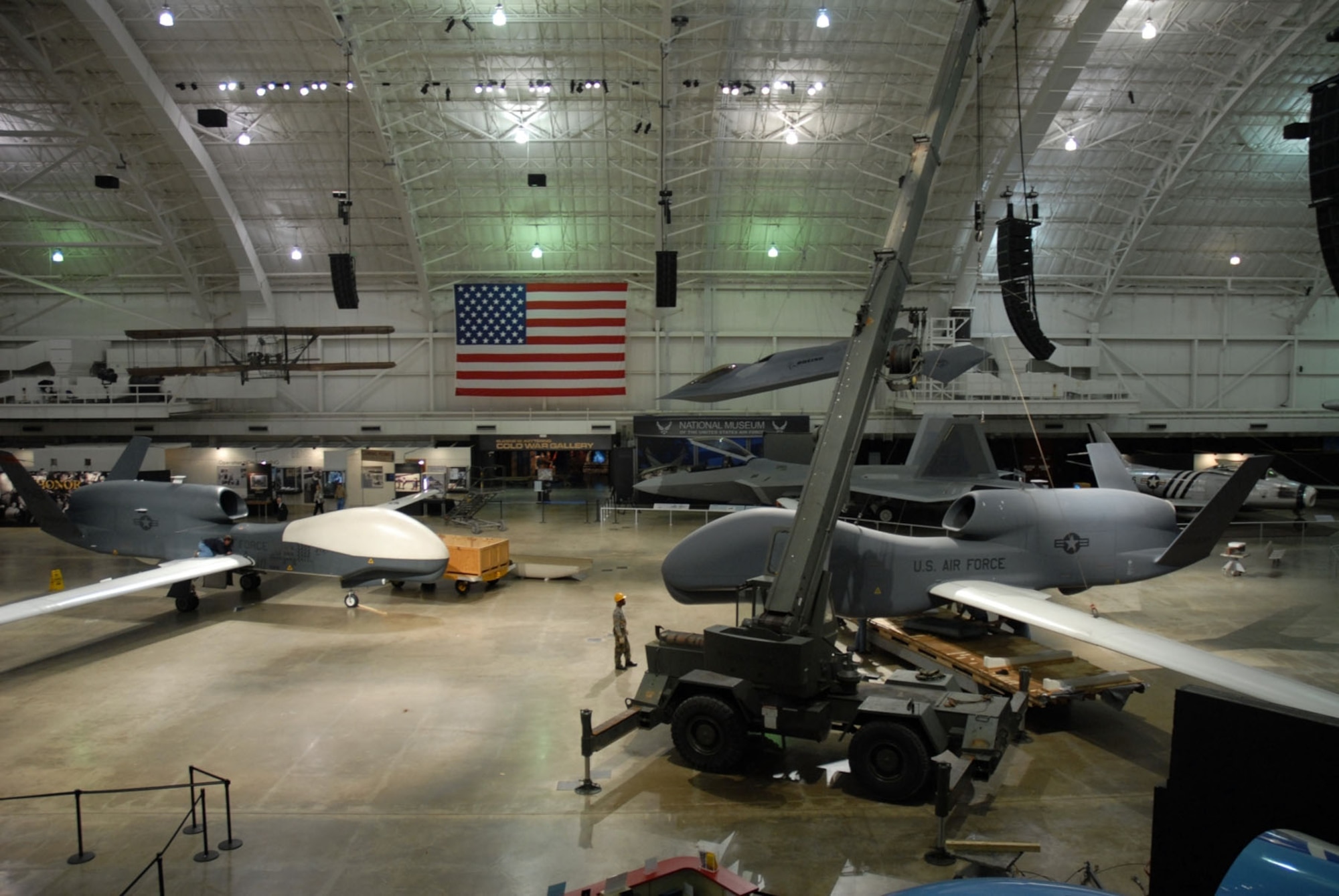 DAYTON, Ohio (05/2008) -- Restoration crews prepare to replace a model of the Global Hawk (right) with the RQ-4 Global Hawk that has seen action in Operation Enduring Freedom (Afghanistan) and in several American and international joint forces exercises. (U.S. Air Force photo)