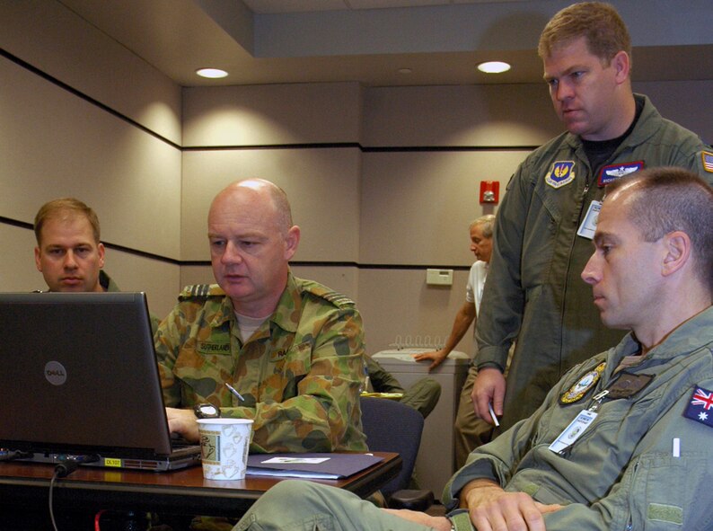 Participants for the Global Mobility Wargame, or GLOMO, 2008, including some from the Royal Australian Air Force, work in the U.S. Air Force Expeditionary Center on Fort Dix, N.J., June 18, 2008.  GLOMO, which began in 2002, helps shape Air Mobility Command?s strategic planning via evaluation of air mobility and logistics capabilities 12 years into the future.  It is also a pre-cursor to the Air Force wargame exercise - Unified Engagement 2008.  (U.S. Air Force Photo/Tech. Sgt. Scott T. Sturkol)
