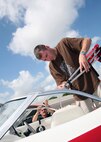 6/14/2008 - Bill Jordan, background, shows Staff Sgt. Kevin Veneman how to engage the canopy of a rental boat at the Lackland Outdoor Adventure Center June 14. (USAF photo by Robbin Cresswell) 
