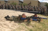 6/13/2008 - Air Force Academy Cadets Lt. Col. Adam Williams (front) and Master Sgt. John Sorce take aim during field training exercises June 13. The cadets were putting on a demonstration for members of the San Antonio Express-News who were visting the base to learn about the various missions of Team Lackland and the Air Force.
(USAF photo by Alan Boedeker)                               